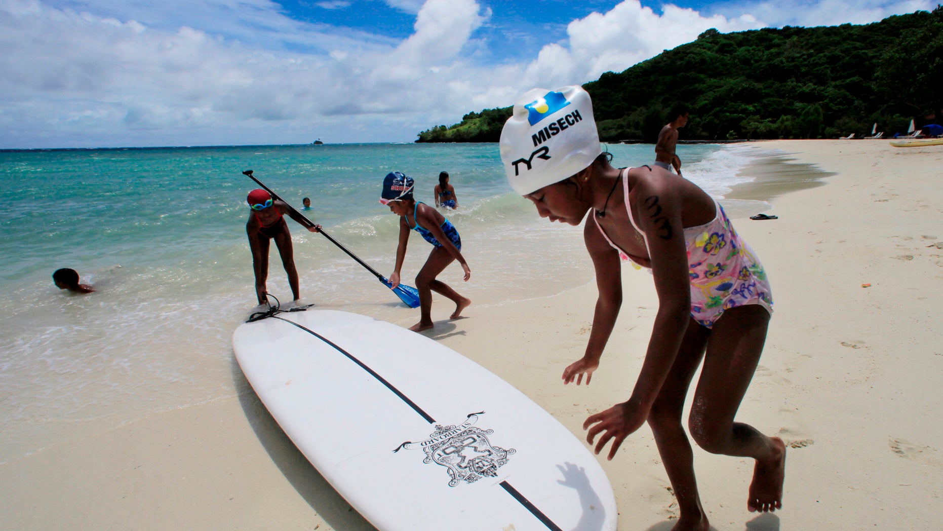 In this June 13, 2009 file photo, children play at a resort beach in Ngerkebesang, Palau.