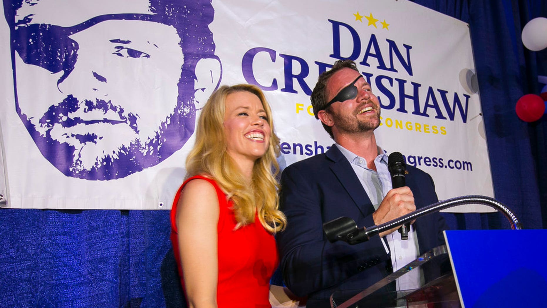 FILE: Republican congressional candidate Dan Crenshaw reacts to the crowd with his wife, Tara, during a party at the Cadillac Bar, in Houston.