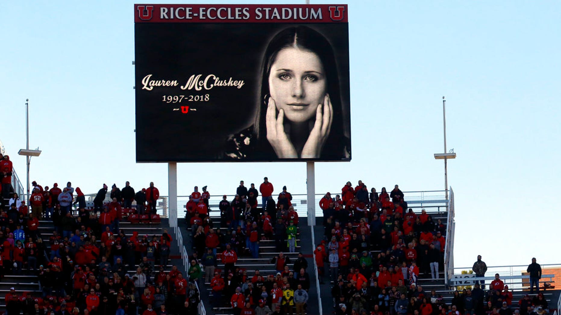 A photo of University of Utah student Lauren McCluskey, who was fatally shot on campus, is projected on the video board as part of a tribute before a football game.