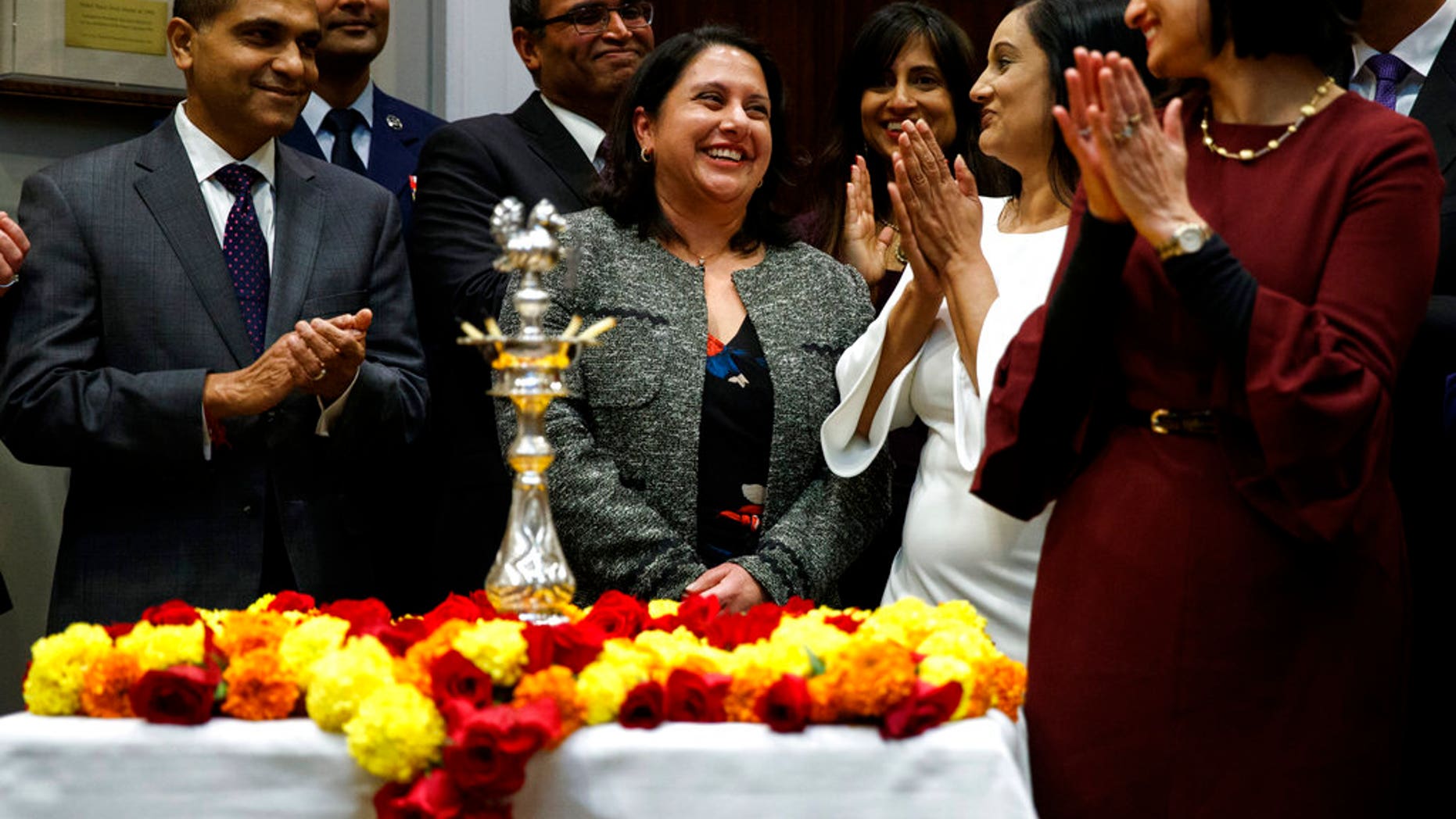 Neomi Rao, Administrator of the Office of Information and Regulatory Affairs, smiles as President Donald Trump announces his intention to nominate her to fill Brett Kavanaugh's seat on the U.S. Court of Appeals for the D.C. Circuit, during a Diwali ceremonial lighting of the Diya in the Roosevelt Room of the White House, Tuesday, Nov. 13, 2018, in Washington. (AP Photo/Evan Vucci)