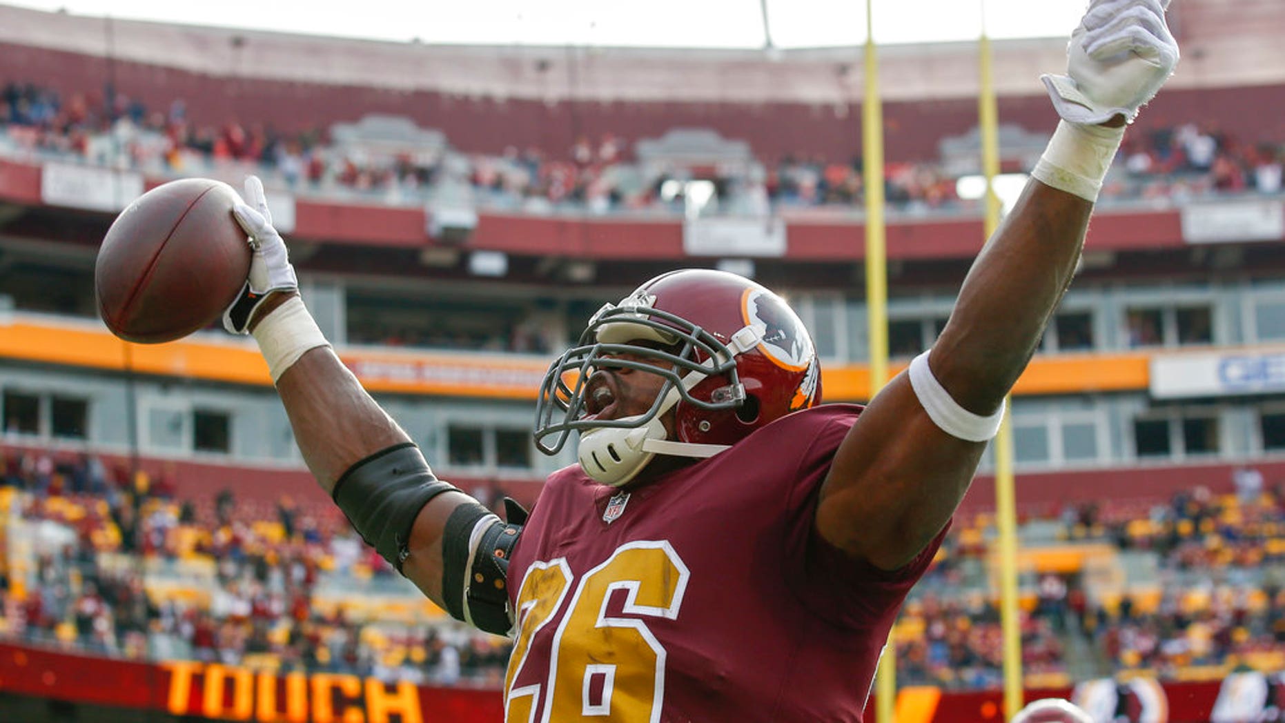 Washington Redskins running back Adrian Peterson (26) celebrates his touchdown during the first half of an NFL football game against the Houston. 