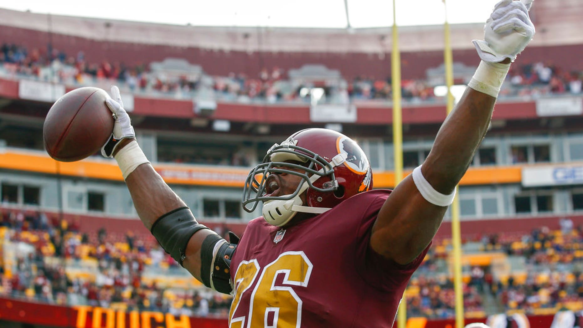 Washington Redskins running back Adrian Peterson (26) celebrates his touchdown during the first half of an NFL football game against the Houston. 