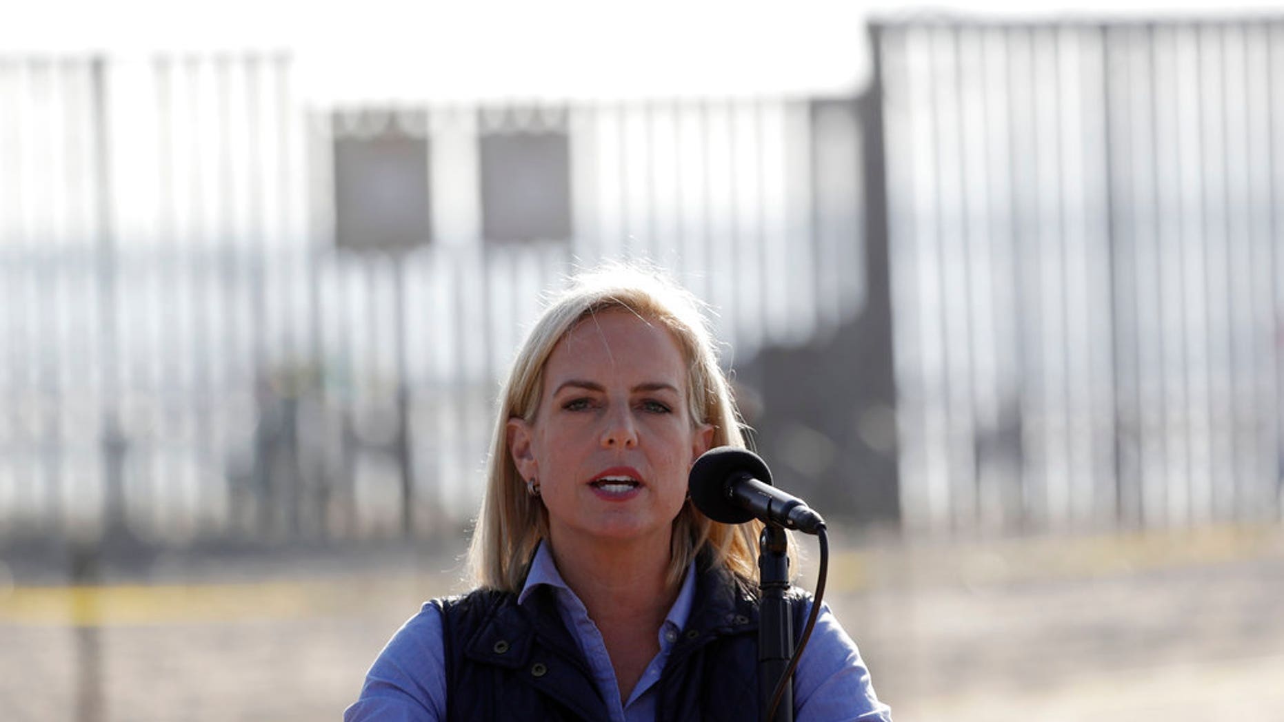 Secretary of Homeland Security Kirstjen Nielsen speaks in front of the border wall separating Tijuana, Mexico, and San Diego.