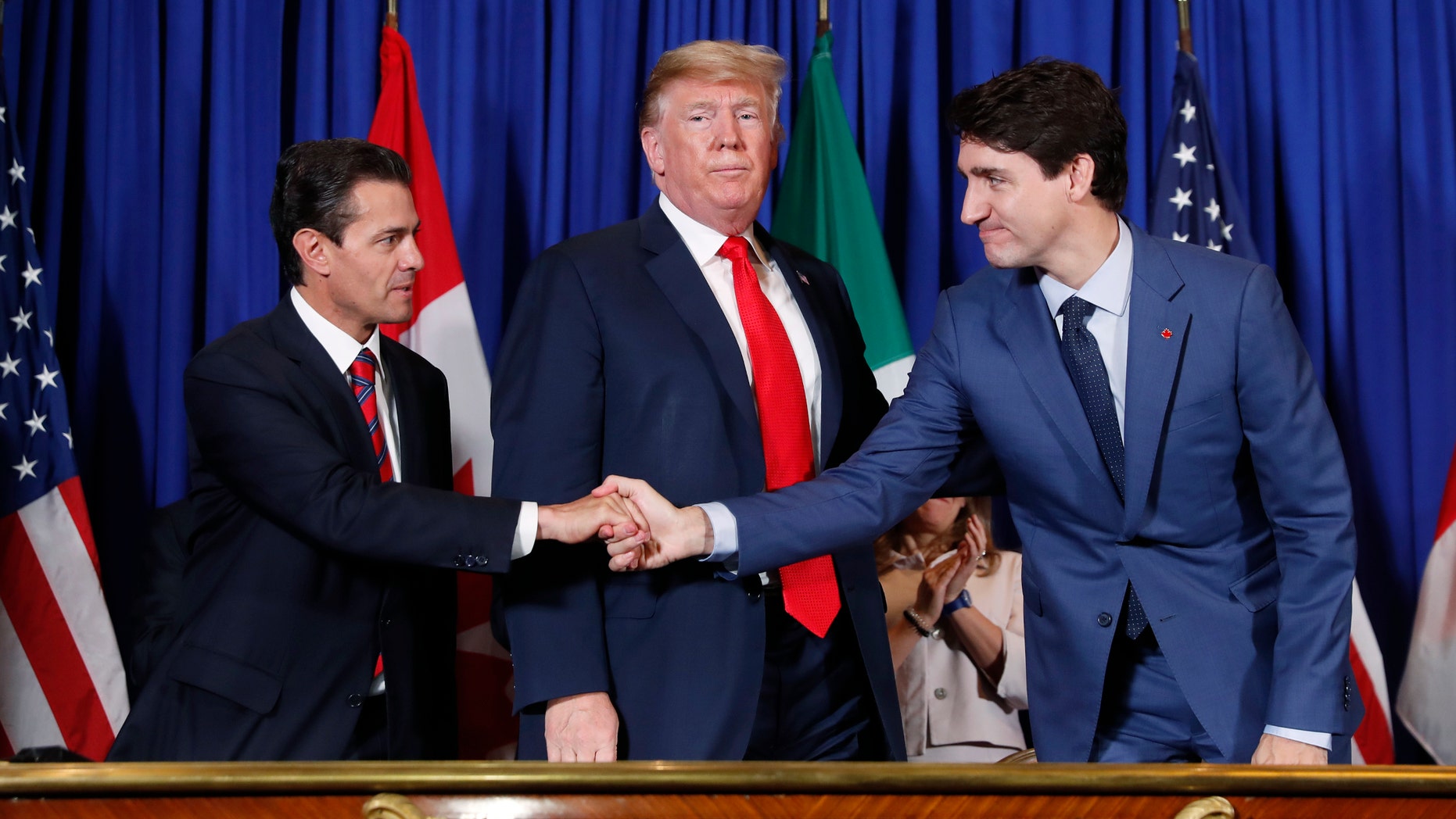 President Donald Trump, Canada's Prime Minister Justin Trudeau, right, and Mexico's President Enrique Pena Neto, left, participate in the USMCA signing ceremony, Friday, Nov. 30, 2018 in Buenos Aires, Argentina. (AP Photo/Pablo Martinez Monsivais)