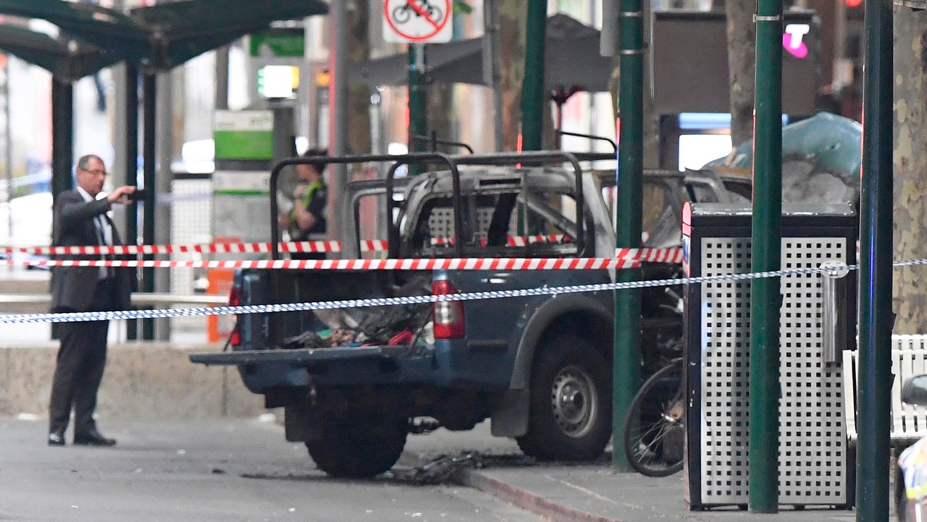 A burnt out vehicle is seen on Bourke Street in Melbourne, Friday, Nov. 9, 2018. 