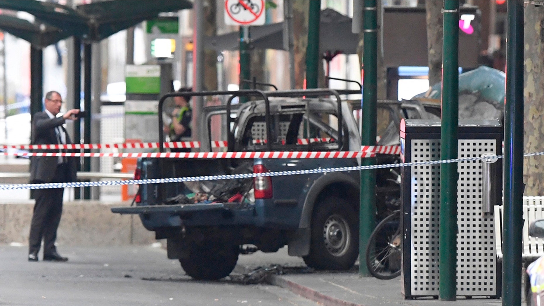 A burnt out vehicle is seen on Bourke Street in Melbourne, Friday, Nov. 9, 2018.
