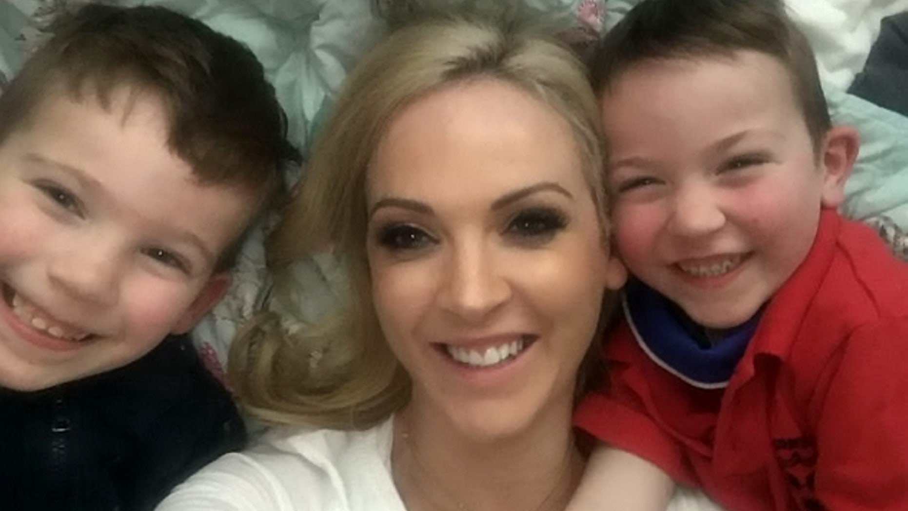 Helen Ross, pictured with her sons, said her heart stopped twice due to "broken heart syndrome," which was brought on by a painful breakup.