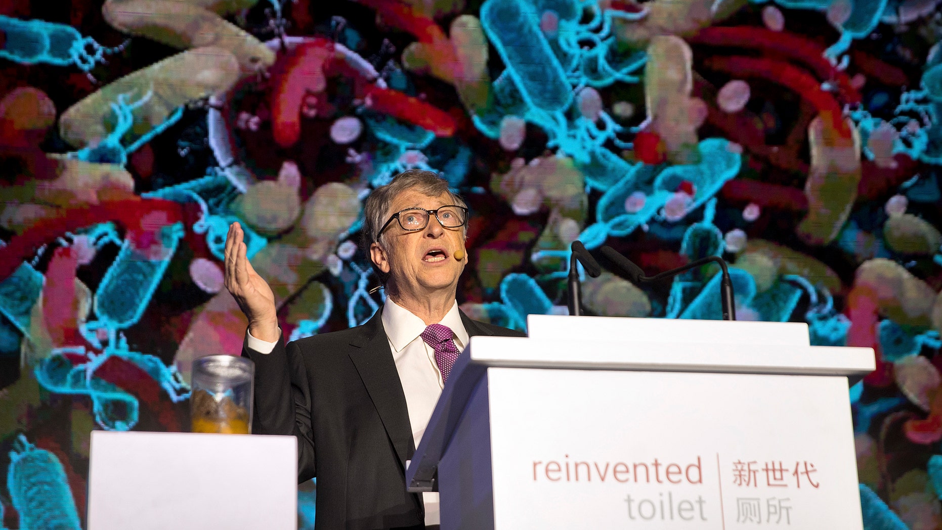 Bill Gates, former Microsoft CEO and co-founder of the Bill and Melinda Gates Foundation, speaks as a jar of human feces sits on a podium at the Reinvented Toilet Expo in Beijing, Tuesday, Nov. 6, 2018.