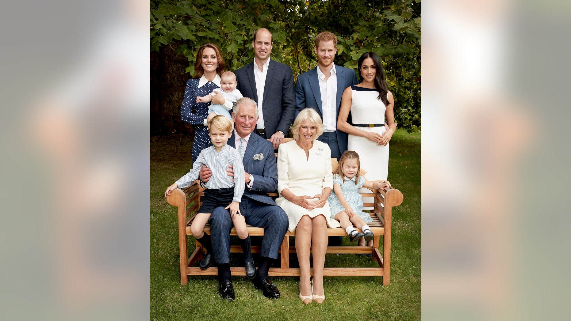 In this handout image provided by Clarence House and taken on Sept. 5, 2018, Britain's Prince Charles poses for an official portrait to mark his 70th Birthday in the gardens of Clarence House, with Camilla, Duchess of Cornwall, Prince William, Kate, Duchess of Cambridge, Prince George, Princess Charlotte, Prince Louis, Prince Harry and Meghan, Duchess of Sussex, in London, England. (Chris Jackson/Pool Photo)