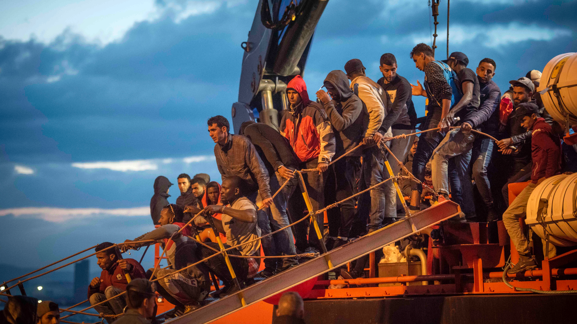 In this photo taken on Saturday, Oct. 27, 2018, migrants arrive at the port of San Roque, southern Spain, after being rescued by Spain's Maritime Rescue Service in the Strait of Gibraltar. Spain's maritime rescue service saved 520 people trying to cross from Africa to Spain's shores on Saturday. Also, one boat with 70 migrants arrived to the Canary Islands. Over 1,960 people have died trying to cross the Mediterranean to Europe this year, according to the United Nations. (AP Photo/Marcos Moreno)