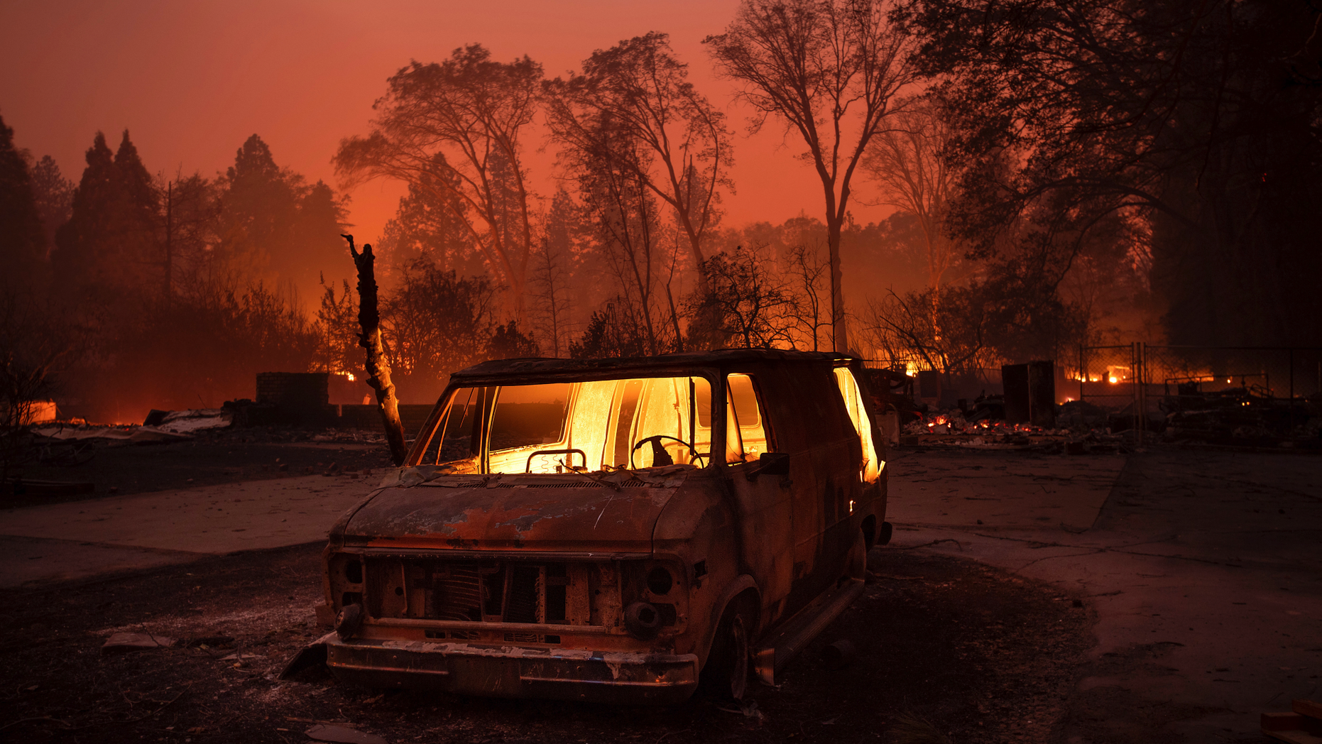 Flames burn inside a van as the Camp Fire tears through Paradise, Calif., on Thursday, Nov. 8, 2018. (AP Photo/Noah Berger, File)