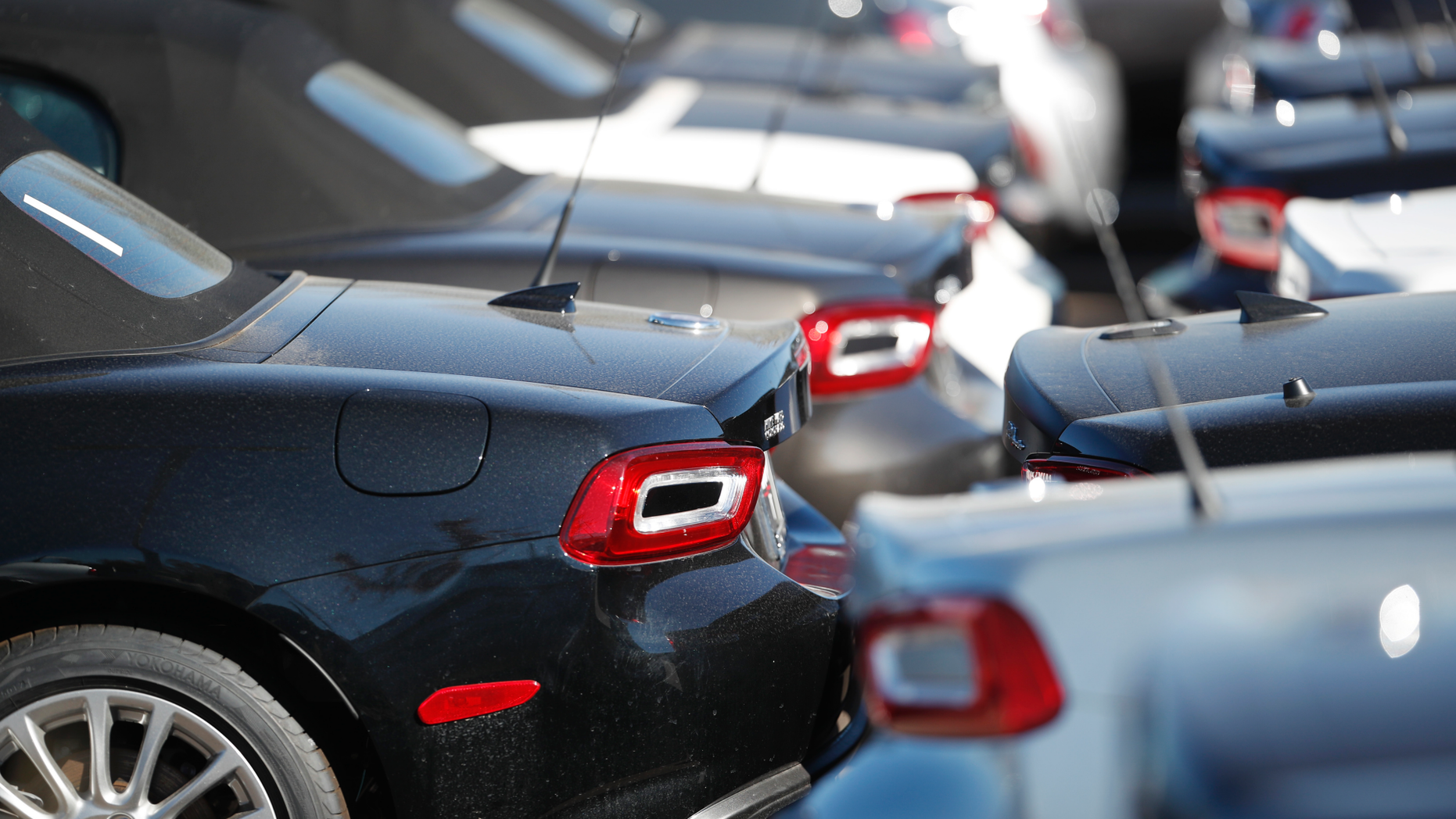 FILE- In this Oct. 21, 2018, file photo a long line of unsold 2018 124 convertibles is shown at a Fiat dealership in Highlands Ranch, Colo. On Wednesday, Nov. 14, the Labor Department reports on U.S. consumer prices for October. (AP Photo/David Zalubowski)