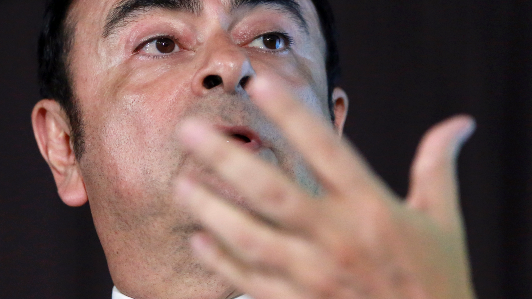FILE - In this May 12, 2016, file photo, head of Nissan Motor Co. Carlos Ghosn answers a question during their joint press conference in Yokohama, near Tokyo. Japanese media say Ghosn, Nissan Motor Co. chairman, is being questioned by Tokyo prosecutors on suspicion he falsified his financial reports. Nissan said Monday it was looking into the reports, while prosecutors declined comment.(AP Photo/Eugene Hoshiko, File)