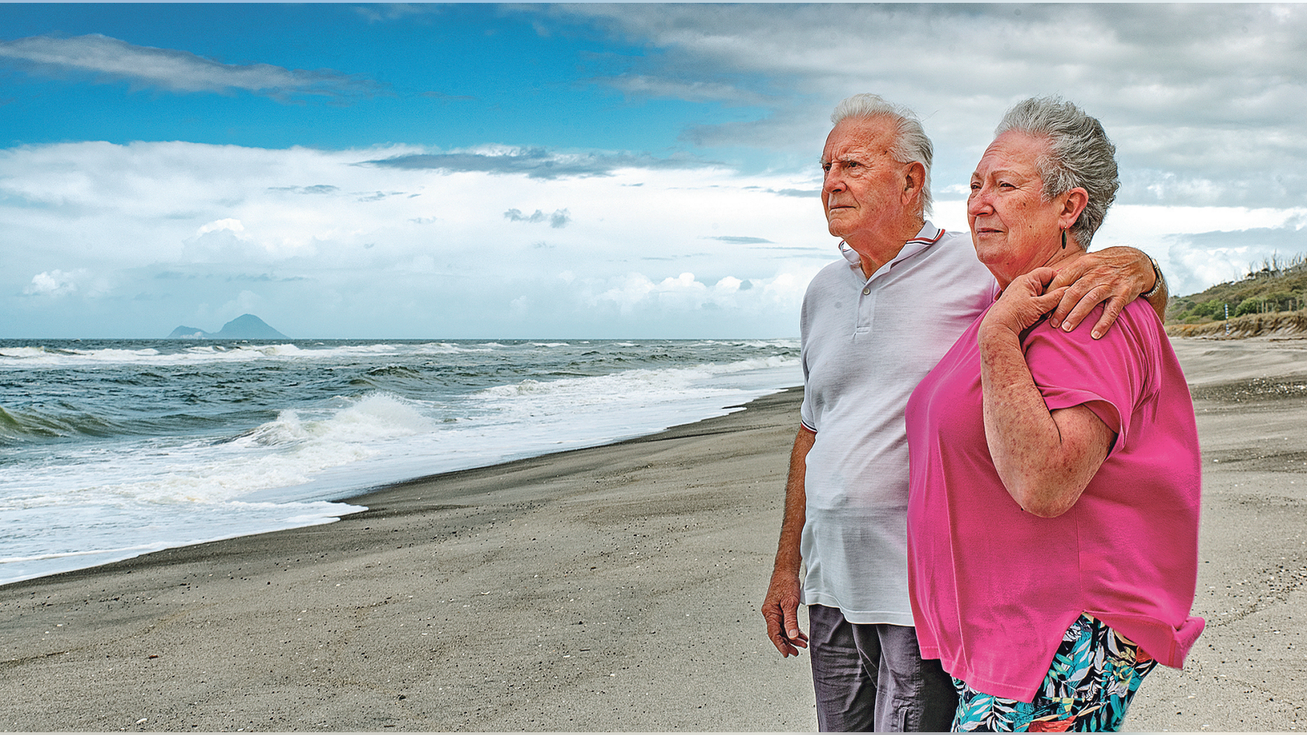 In this Oct. 29, 2018 photo fisherman Gus Hutt is with his wife Sue where he saved saved 18-month-old Malachi Reeve after he had escaped from his parents' tent at Matata Beach, near Whakatane, New Zealand. Hutt was fishing when he plucked a toddler from the ocean in a "miraculous" rescue after thinking he was watching a doll float past. (Troy Baker/Whakatane Beacon via AP)
