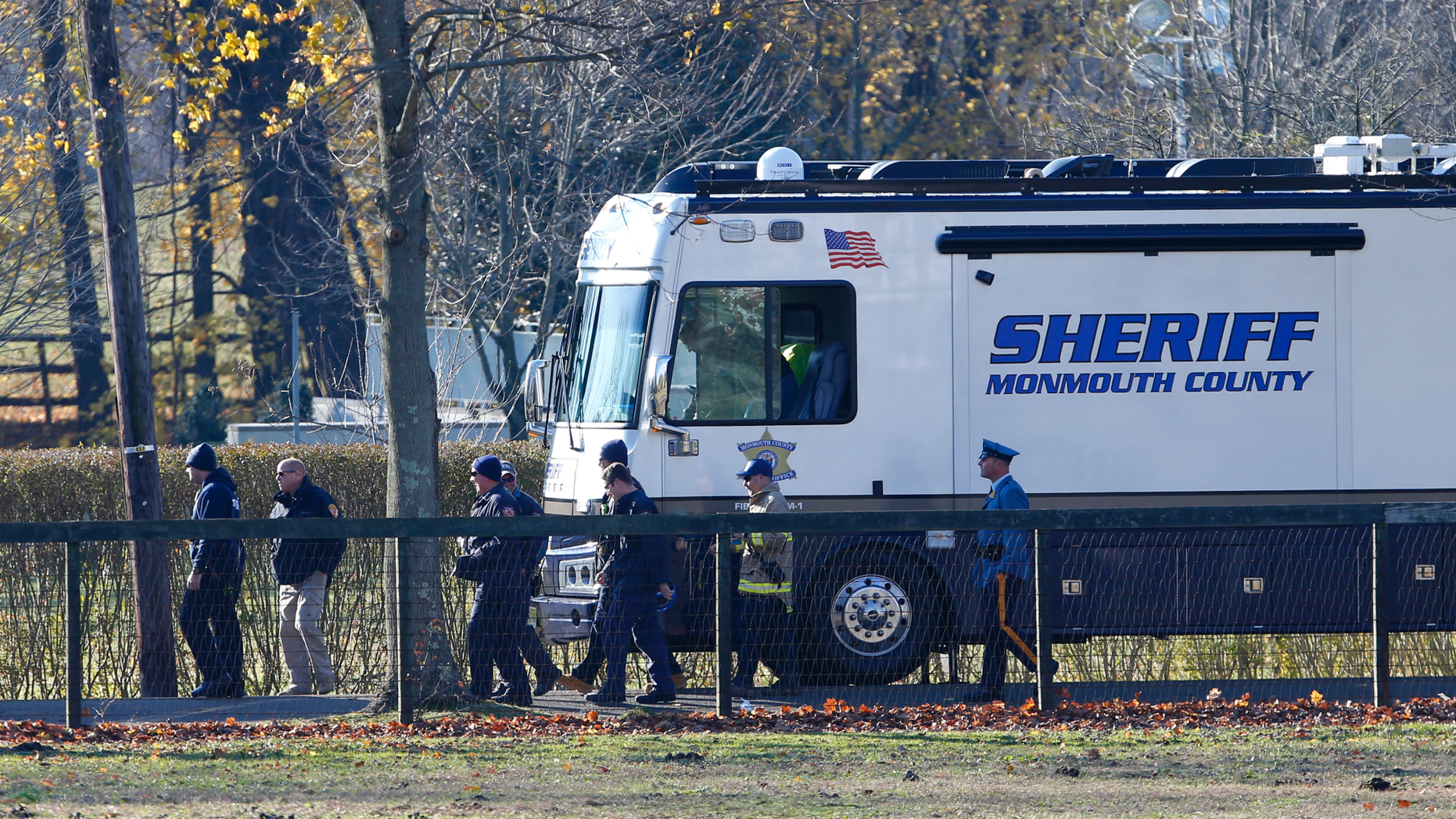 Law enforcement officials met Wednesday, November 21, 2018 in Colts Neck, NJ, to investigate the consequences of a deadly fire that killed two children and two adults. Authorities say two adults and two children were found dead the day before at the site of a mansion on fire near New Jersey Shore. (AP Photo / Noah K. Murray)