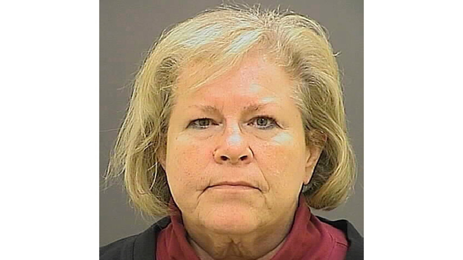 FILE - This undated file photo provided by the Baltimore Police Department shows former Episcopal Bishop Heather Cook. A Maryland judge is set to decide whether to reduce a prison sentence for the former Episcopal bishop who was drunk and texting when she struck and killed a bicyclist with her vehicle. The Baltimore Sun reports that Baltimore Circuit Judge Timothy Doory is scheduled to preside over a hearing Monday, Nov. 5, 2018, for Cook's request for a reduction in her five-year sentence. The 62-year-old Cook has served approximately three years of her sentence for the 2014 collision that killed Thomas Palermo. (Baltimore Police Department via AP, File)
