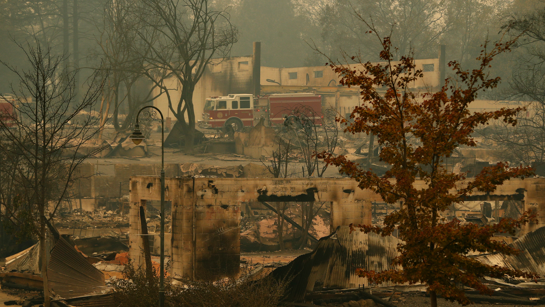 A fire truck drives through an area burned in the wildfire, Tuesday, Nov. 13, 2018, in Paradise, Calif. Five days after flames all but obliterated the Northern California town, officials were unsure of the exact number of missing. But the death toll was almost certain to rise. (AP Photo/John Locher)