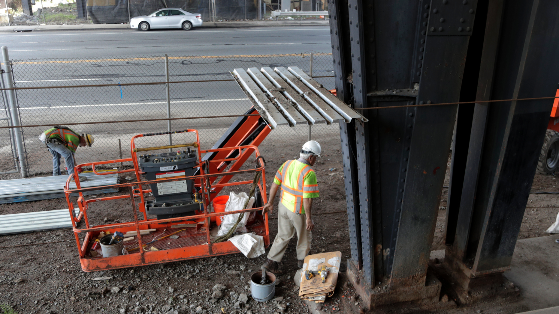 FILE- In this Aug. 15, 2018, file photo workers labor on scaffolding below the Route 495 viaduct ahead of a project to remodel the bridge which feeds into the Lincoln Tunnel in North Bergen, N.J. On Thursday, Nov. 1, the Commerce Department reports on U.S. construction spending in September. (AP Photo/Julio Cortez, File)