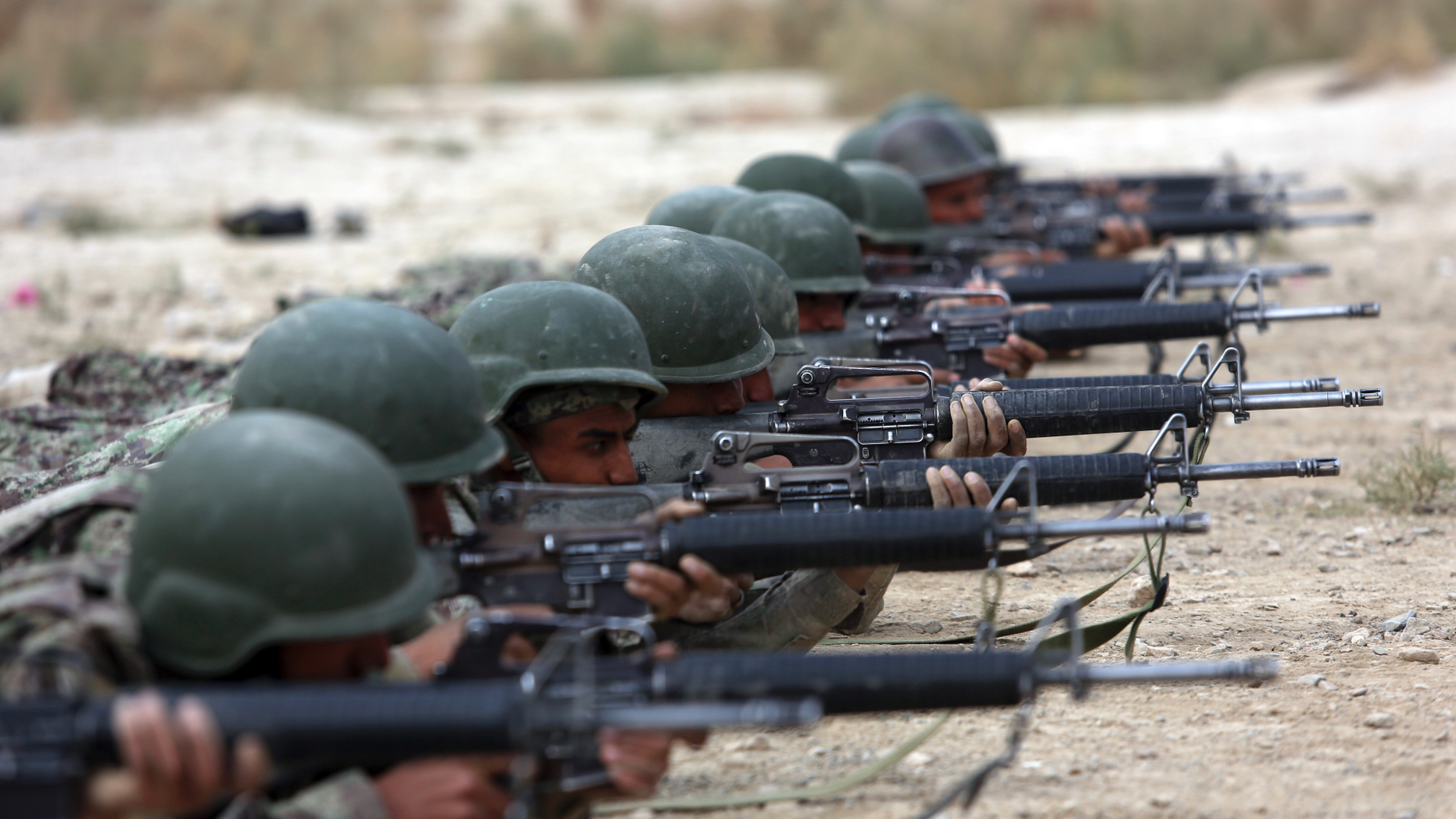 FILE - In this Oct. 31, 2018, file photo, Afghan National Army soldiers participate in a live fire training exercise, at the Afghan Military Academy, in Kabul, Afghanistan. A new assessment of U.S.-led efforts to compel the Taliban to negotiate a peace deal in Afghanistan says there has been “little clear progress” in recent months. (AP Photo/Rahmat Gul, File)
