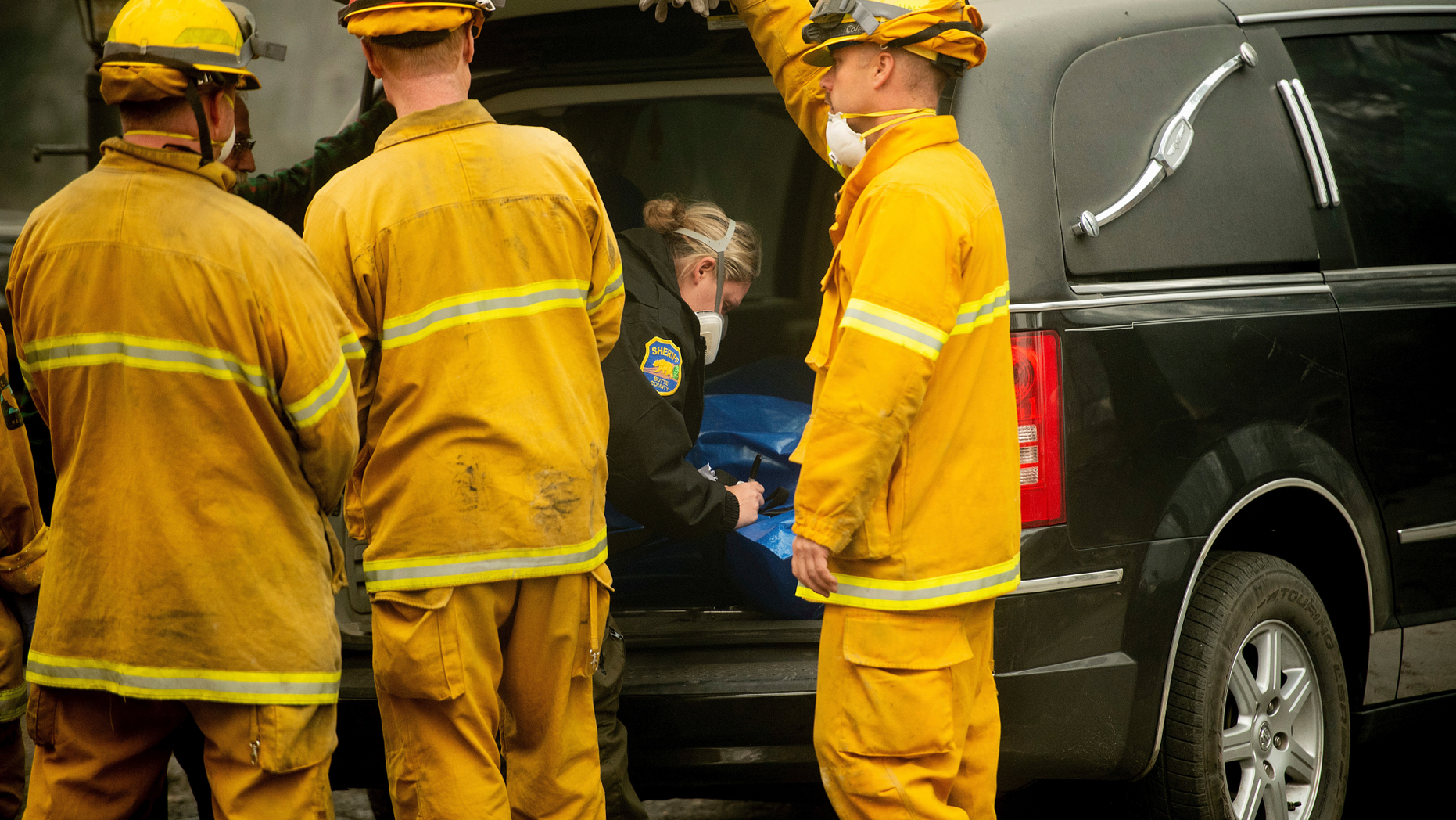 A Butte County sheriff's deputy makes a note while recovering the body of a Camp Fire victim at the Holly Hills Mobile Estates on Wednesday, Nov. 14, 2018, in Paradise, Calif. Thousands of homes were destroyed when flames hit Paradise, a former gold-mining camp popular with retirees, on Nov. 8, killing multiple people in California's deadliest wildfire. (AP Photo/Noah Berger)
