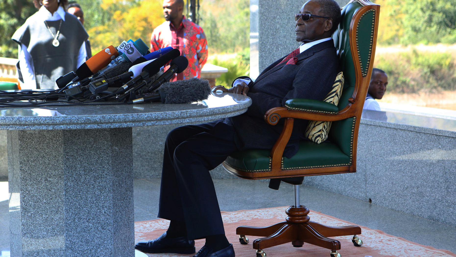 FILE - In this Sunday, July 29, 2018 file photo, former Zimbabwean President Robert Mugabe holds a press briefing at his residence in Harare. Zimbabwe's former president Robert Mugabe is no longer able to walk as his health declines, his successor says. President Emmerson Mnangagwa told ruling party supporters at a rally Saturday, Nov. 24 that the 94-year-old Mugabe has been in a hospital in Singapore for the past two months. (AP Photo/Tsvangirayi Mukwazhi, file)