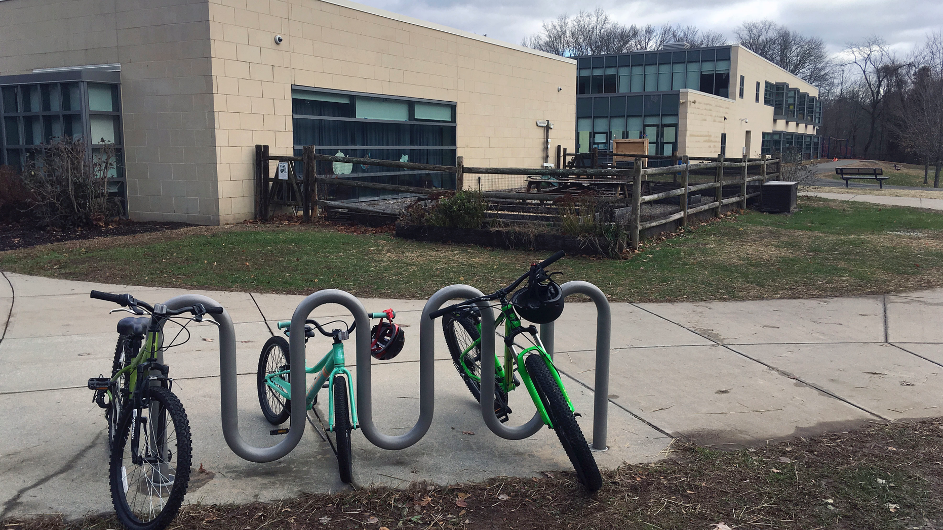 Bicycles are parked outside the Tokeneke Elementary School Tuesday, Nov. 27, 2018, in Darien, Conn. The Darien school system said parents are no longer welcome to have lunch with their children at the town's elementary schools. (AP Photo/Michael Melia)