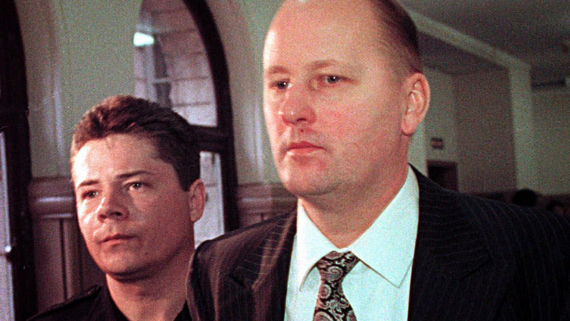 FILE - In a Thursday, April 15, 1999 file photo, Tim Boczkowski is led away from a courtroom in Pittsburgh, Pa., who was convicted of killing two of his wives in two states could be released from a North Carolina prison, potentially cutting short his life sentence after more than 22 years. North Carolina's parole commission said Wednesday, Nov. 7, 2018, it was collecting information ahead of a decision on whether to release Tim Boczkowski. (AP Photo/Gary Tramontina)