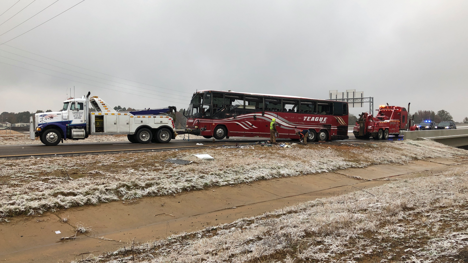 A tour bus is towed away Wednesday, Nov. 14, 2018, after it overturned on an icy highway in northern Mississippi. DeSoto County sheriff's deputy Alex Coker said the tour bus carrying about 50 people overturned just after midday Wednesday south of Memphis, Tennessee. The crash came as a winter storm has been raking parts of the South. The county coroner, Josh Pounders, says two people are confirmed dead in the crash where Interstate 269 meets with Interstate 22. He says that the injured have been taken to area hospitals, some in critical condition. (AP Photo/Adrian Sainz)