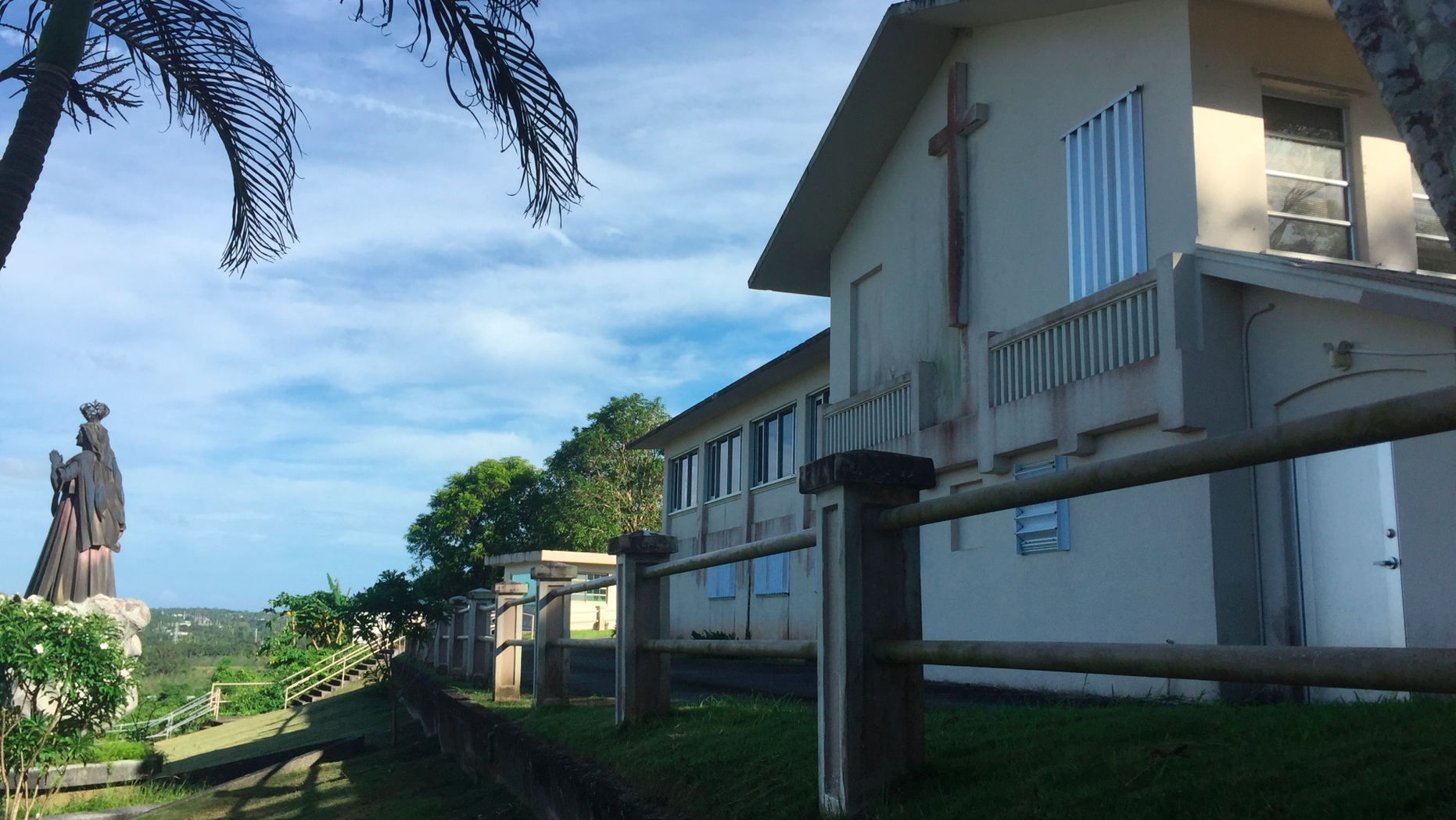 This photo shows the residence and office of the Archbishop of Agana in Guam on Wednesday, Nov. 7, 2018. The house was listed as one of the non-essential properties owned by the Catholic Church in Guam, which announced on Wednesday that it will file for Chapter 11 reorganization bankruptcy to avoid trial in dozens of lawsuits alleging child sexual abuse by priests and move toward settlements. The funds for future victims claims will come from the sale of non-essential church properties and insurance. (AP Photo/Grace Garces Bordallo)