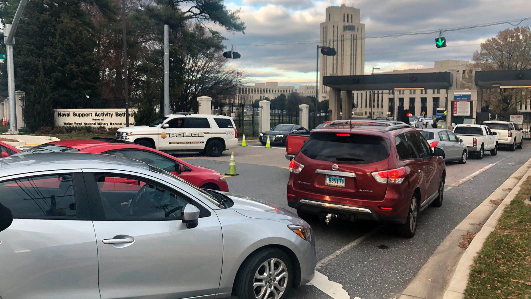 Cars are prevented from entering or exiting the Walter Reed National Military Medical Center, Tuesday, Nov. 27, 2018 in Bethesda, Md. Security officers found "no indication" of an active shooter after reports from Walter Reed National Military Medical Center outside Washington, officials said Tuesday.Naval Support Activity Bethesda tweeted at 2:15 p.m. that an active shooter had been reported in the basement of a building at the Maryland base. (AP Photo/Michael Kunzelman)