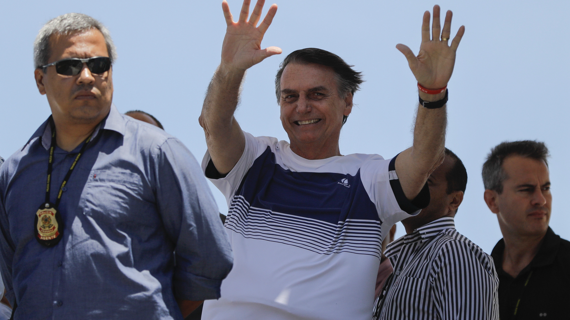 Brazil's President-elect Jair Bolsonaro waves at supporters as he arrives to watch an aerial performance by the private pilots' group “Esquadrilha do Ceu" or “Sky Squadron", at Barra beach in Rio de Janeiro, Brazil, Wednesday, Oct. 31, 2018. Bolsonaro appeared in public Tuesday for the first time as president-elect. He visited a church led by ultraconservative pastor Silas Malafaia and spoke briefly to the faithful on stage. "I am sure that I am not the most capable, but God capacitates the chosen ones," he said. (AP Photo/Leo Correa)