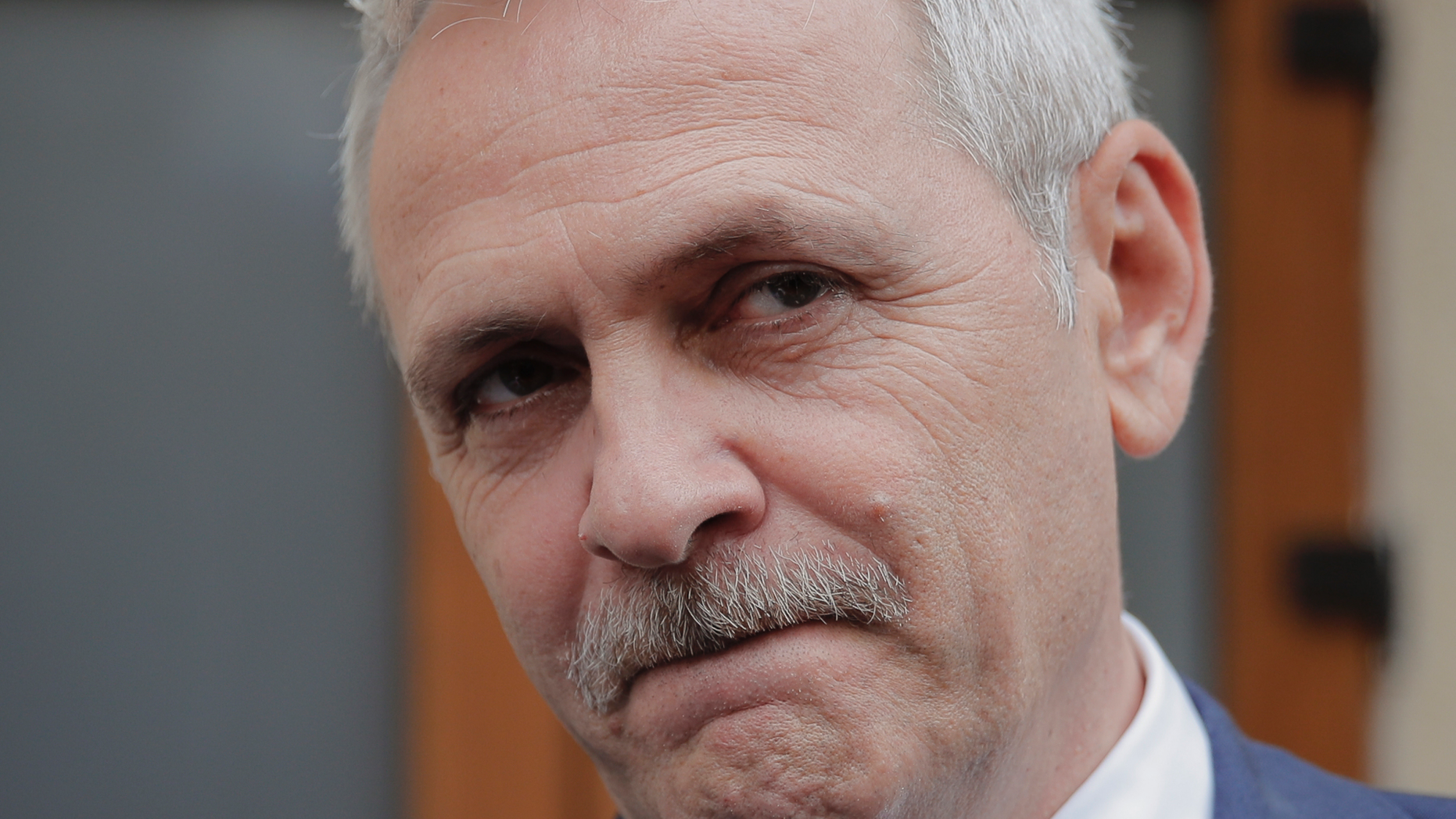 FILE - In this April 27, 2018 file photo, the leader of Romania's ruling Social Democratic party, Liviu Dragnea, grimaces as he walks out of the anti-corruption prosecutors' office, in Bucharest, Romania. Romania’s ruling Social Democratic Party fired six ministers on Monday, Nov. 19, 2018, as Dragnea sought to tighten his grip on the government. (AP Photo/Vadim Ghirda, File)