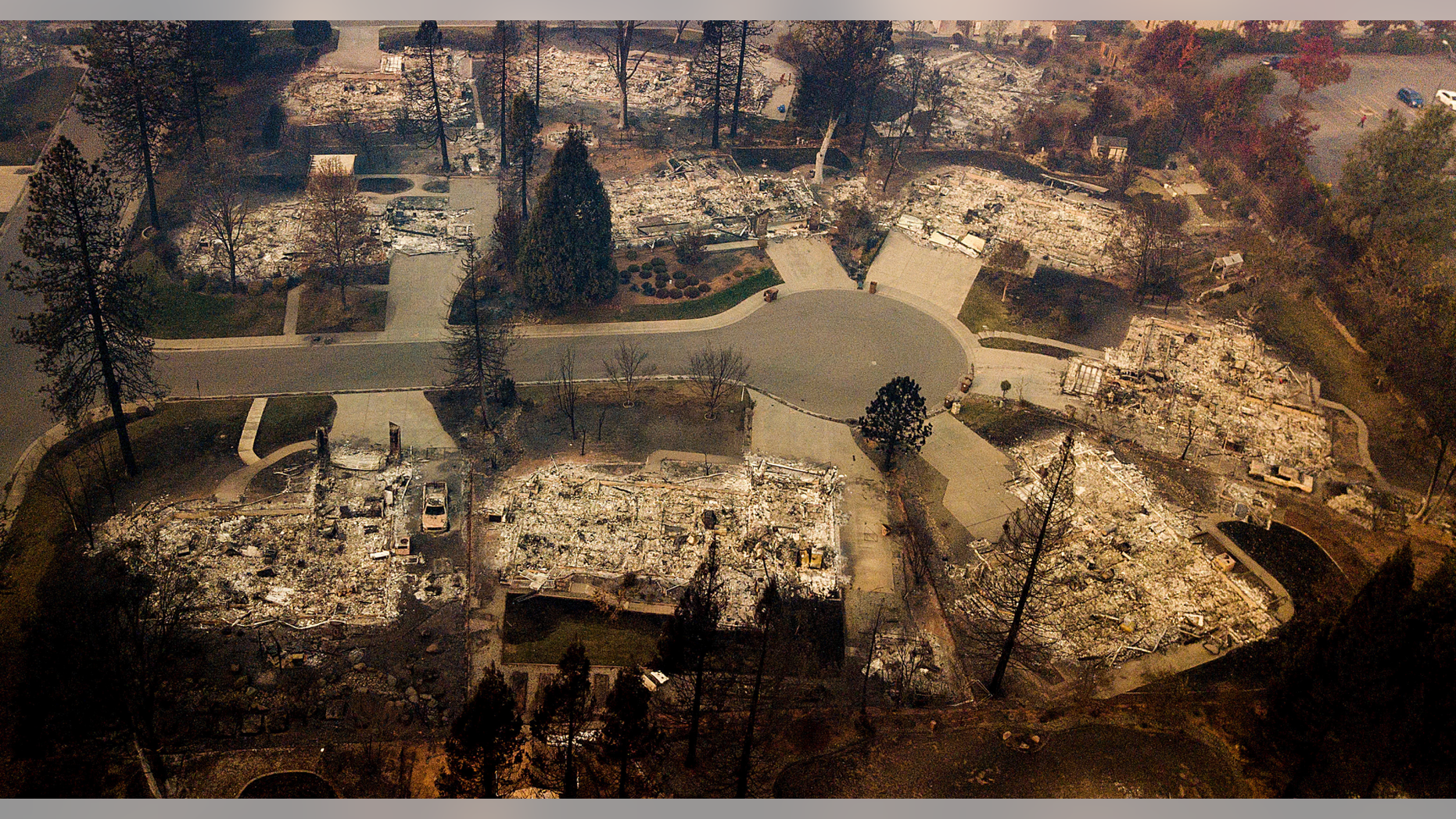 Residences leveled by the Camp Fire line a cul-de-sac in Paradise, Calif., on Thursday, Nov. 15, 2018. The California Department of Forestry and Fire Protection said Thursday the wildfire that destroyed the town of Paradise is now 40 percent contained, up from 30 percent Wednesday morning. (AP Photo/Noah Berger)