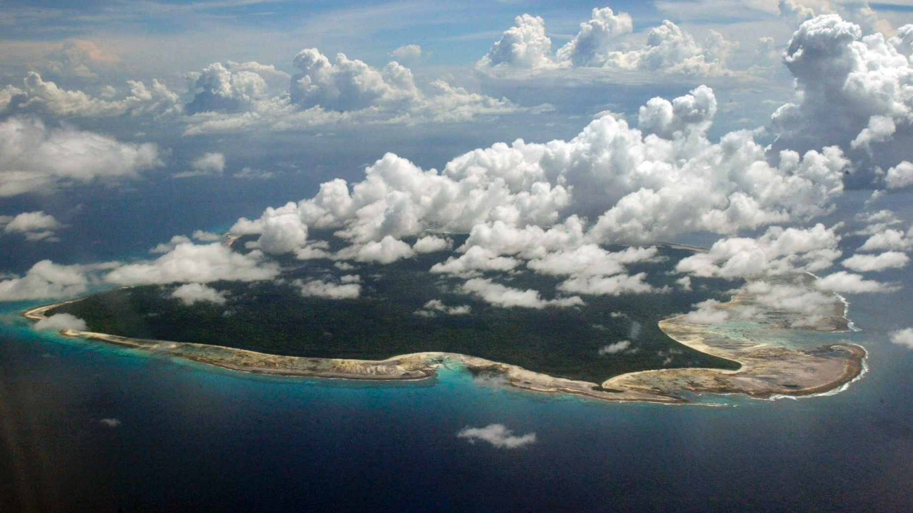 FILE – In this Nov. 14, 2005 file photo, clouds hang over the North Sentinel Island, in India's southeastern Andaman and Nicobar Islands. An American is believed to have been killed by an isolated Indian island tribe known to fire at outsiders with bows and arrows, Indian police said Wednesday, Nov. 21, 2018.
Police officer Vijay Singh said seven fishermen have been arrested for facilitating the American's visit to North Sentinel Island, where the killing apparently occurred. Visits to the island are heavily restricted by the government. (AP Photo/Gautam Singh, File)