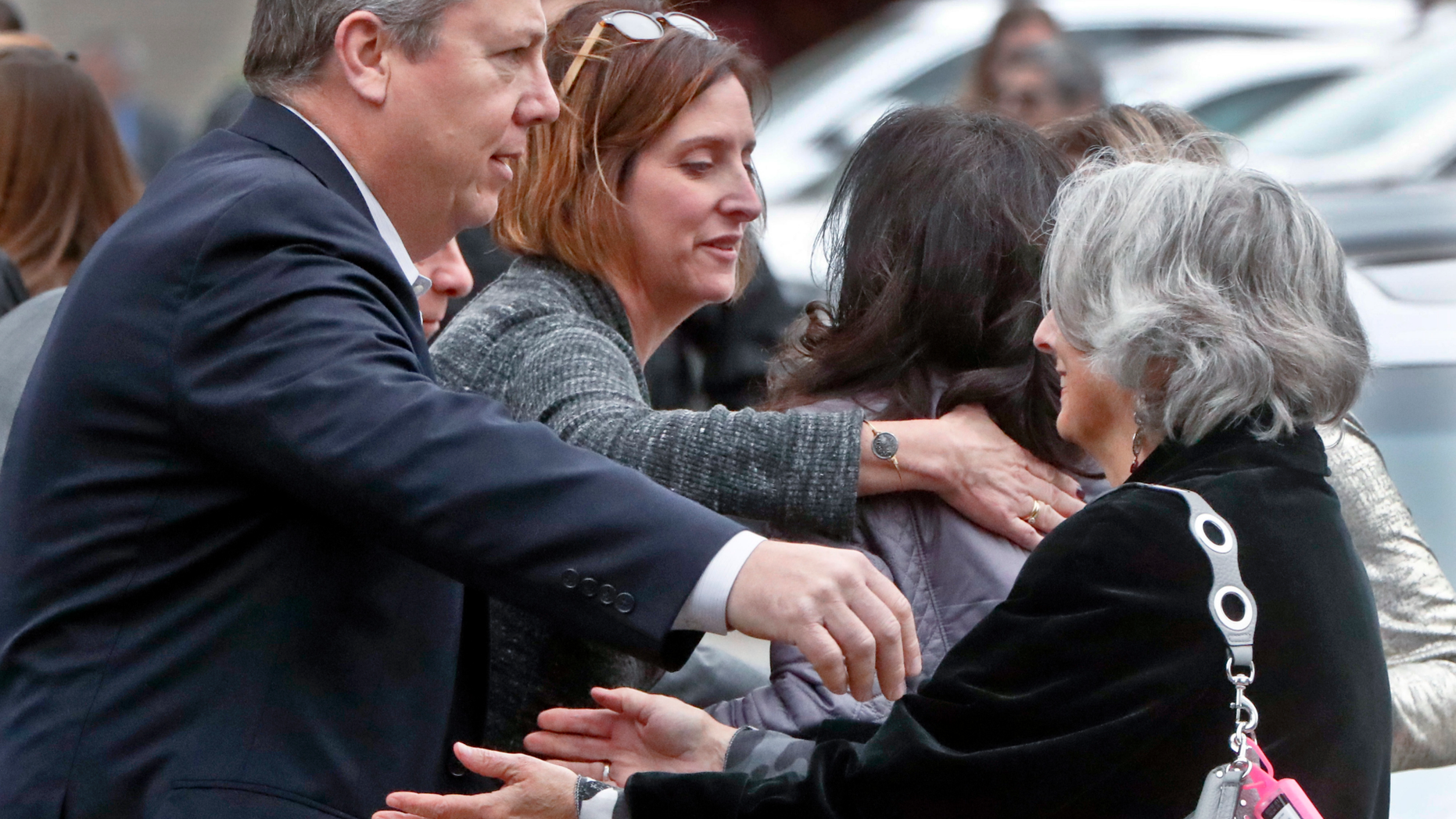 Visitors reach for each other as they gather for the funeral of Rose Mallinger, 97, at Congregation Rodef Shalom on Friday, Nov. 2, 2018, in Pittsburgh. Mallinger was one of the eleven victims killed in the deadly shooting at a synagogue in Pittsburgh's Squirrel Hill neighborhood last Saturday. (AP Photo/Keith Srakocic)