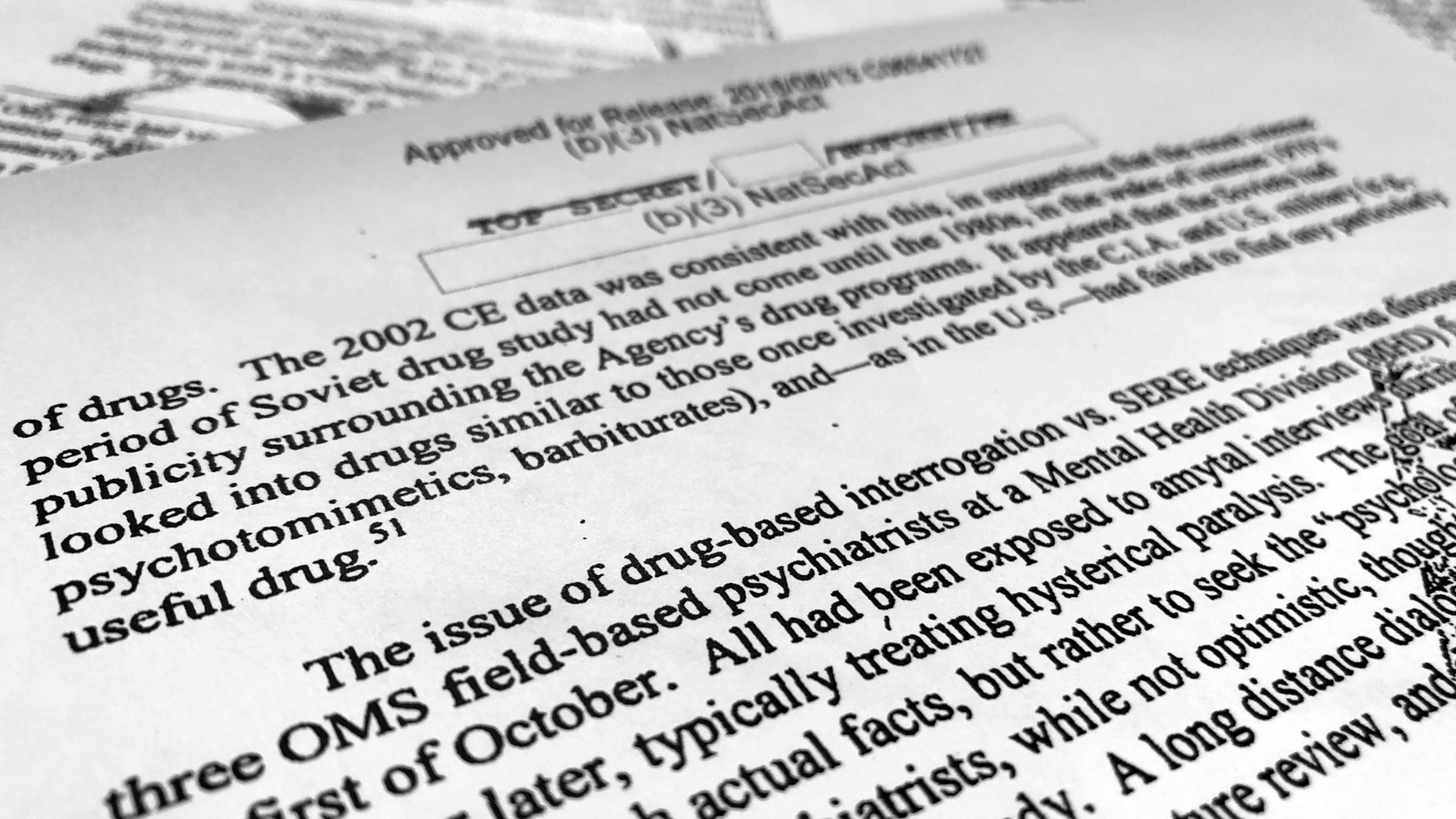A portion of a once-classified CIA report that disclosed the existence of a drug research program dubbed "Project Medication" is photographed in Washington, Tuesday, Nov. 13, 2018. Shortly after 9/11, the CIA considered using a drug that might work like a truth serum and force terror suspects to give up information about potential attacks. After months of research, the agency decided that a drug called Versed, a sedative often prescribed to reduce anxiety, was “possibly worth a try.” But in the end, the CIA decided not to ask government lawyers to approve its use. The American Civil Liberties Union fought in court to have the report released. (AP Photo/Jon Elswick