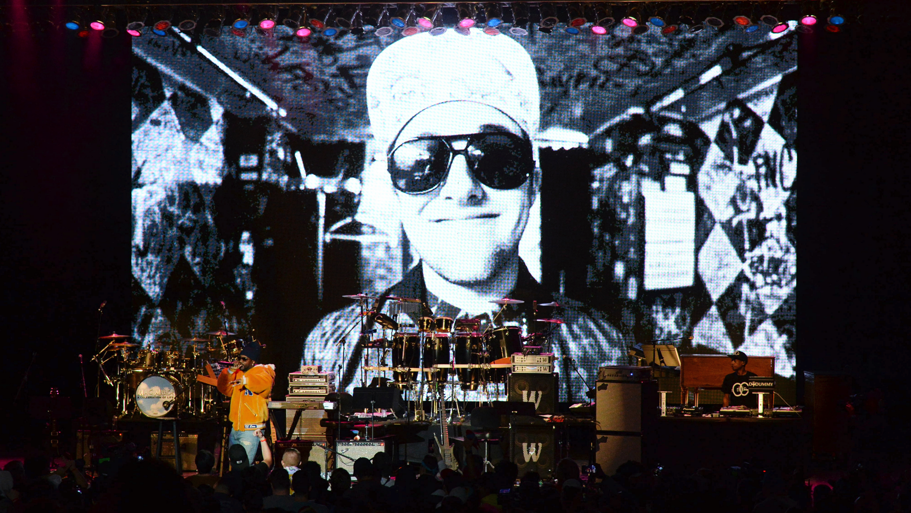 Juicy J performs during the tribute event Mac Miller: A Celebration of Life on Wednesday, Oct. 31, 2018, at the Greek Theatre in Los Angeles. Pictured on screen is the late rapper Mac Miller. (Photo by Amy Harris/Invision/AP)