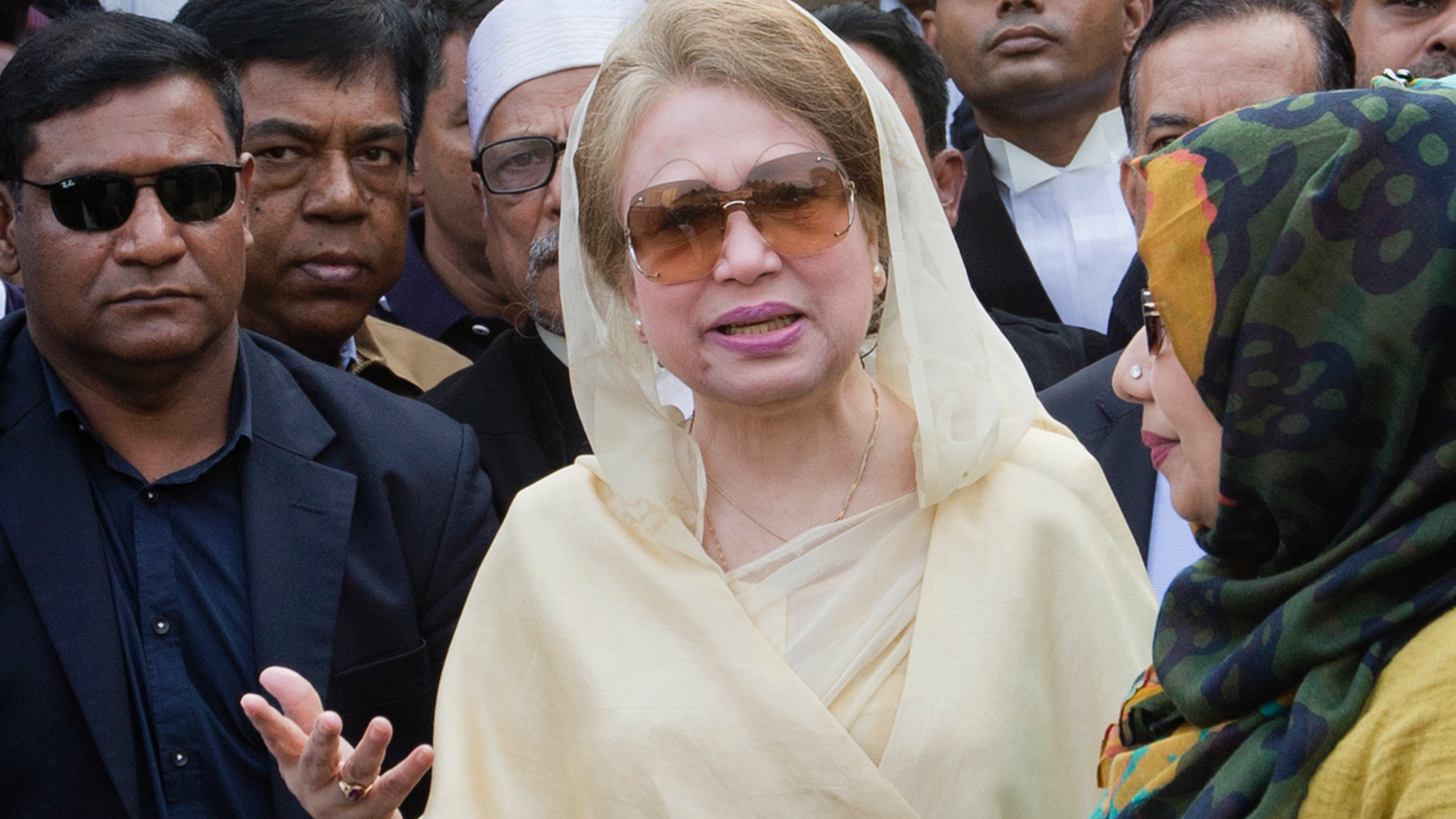 FILE- In this Dec. 28, 2017 file photo, Bangladesh's former prime minister and opposition leader Khaleda Zia, center, leaves after a court appearance in Dhaka, Bangladesh. Bangladesh's Election Commission announced Thursday that the next national election will be held Dec. 23, despite the imprisonment of the main opposition leader. (AP Photo/A.M. Ahad, File)