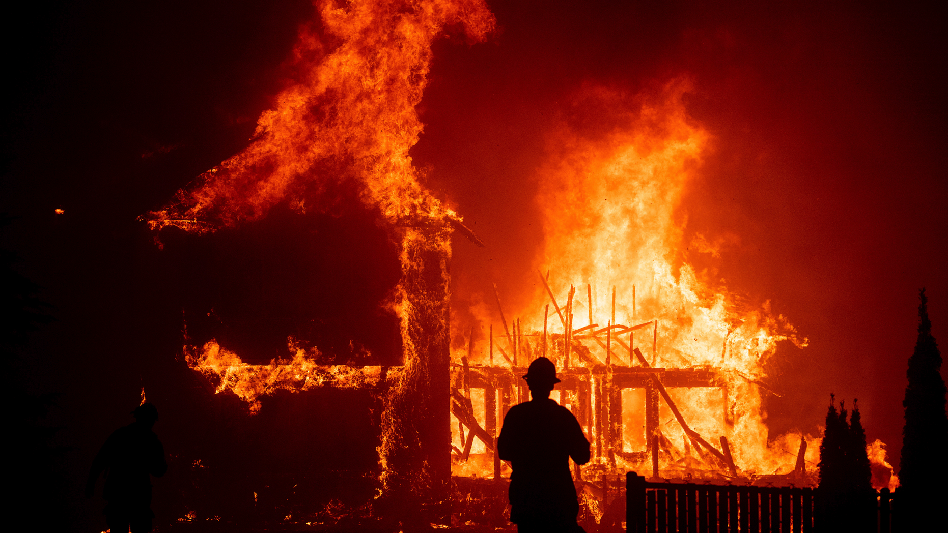 A home burns as the Camp Fire rages through Paradise, Calif., on Thursday, Nov. 8, 2018. Tens of thousands of people fled a fast-moving wildfire Thursday in Northern California, some clutching babies and pets as they abandoned vehicles and struck out on foot ahead of the flames that forced the evacuation of an entire town.(AP Photo/Noah Berger)