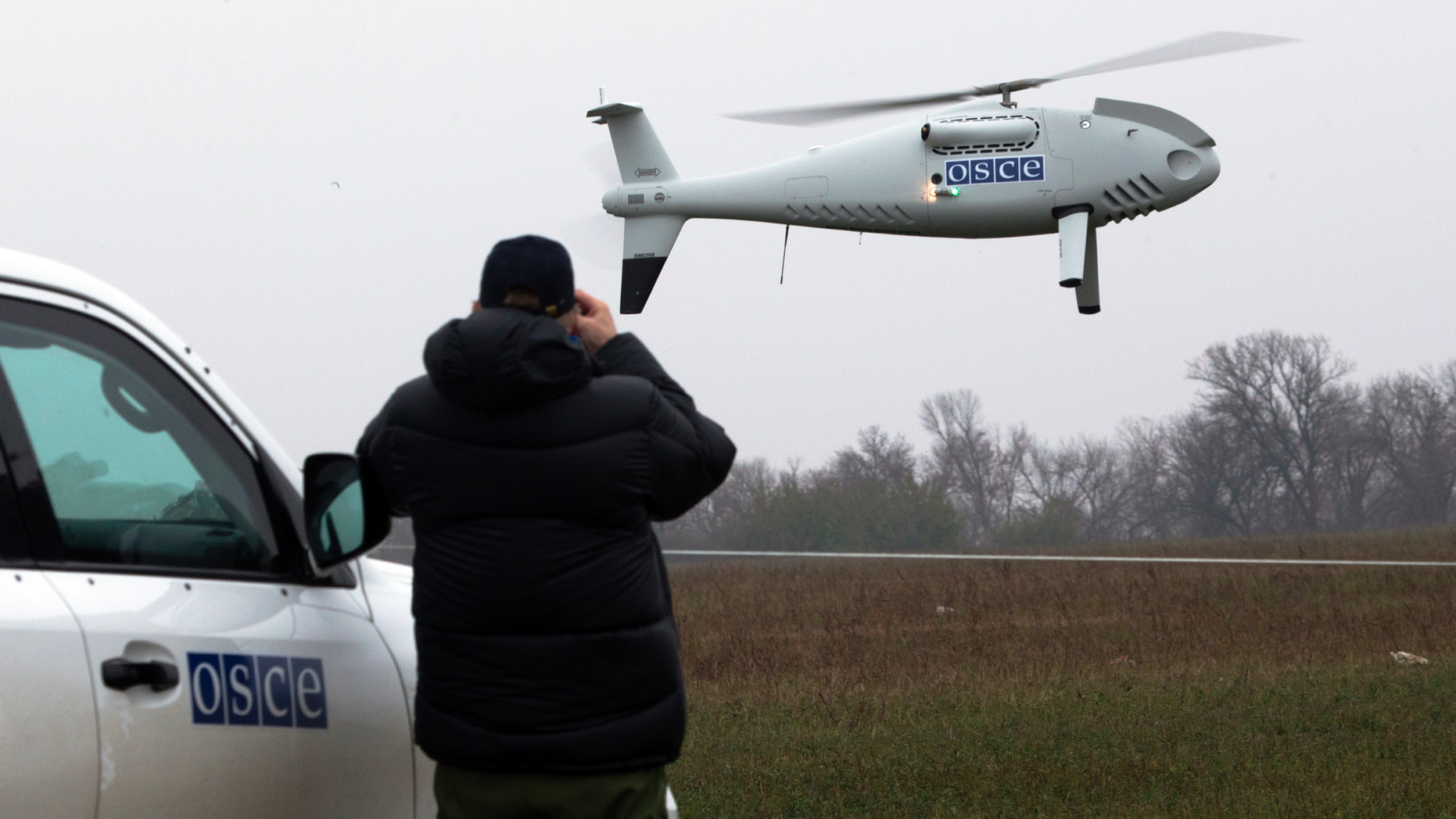 FILE - In this Thursday, Oct. 23, 2014 file photo, a member of the Organization for Security and Co-operation in Europe (OSCE) mission to Ukraine watches a drone take off during a test flight near the town of Mariupol, eastern Ukraine. Germany and France say it appears that Russian-backed separatists in Ukraine downed a drone being used by neutral European observers and are demanding accountability. In a joint statement, they said Thursday, Nov. 1, 2018 the downing is a "clear violation" of the Organization for Security and Cooperation in Europe's Special Monitoring Mission in Ukraine, which is to have unimpeded access. (AP Photo/Dmitry Lovetsky, file)