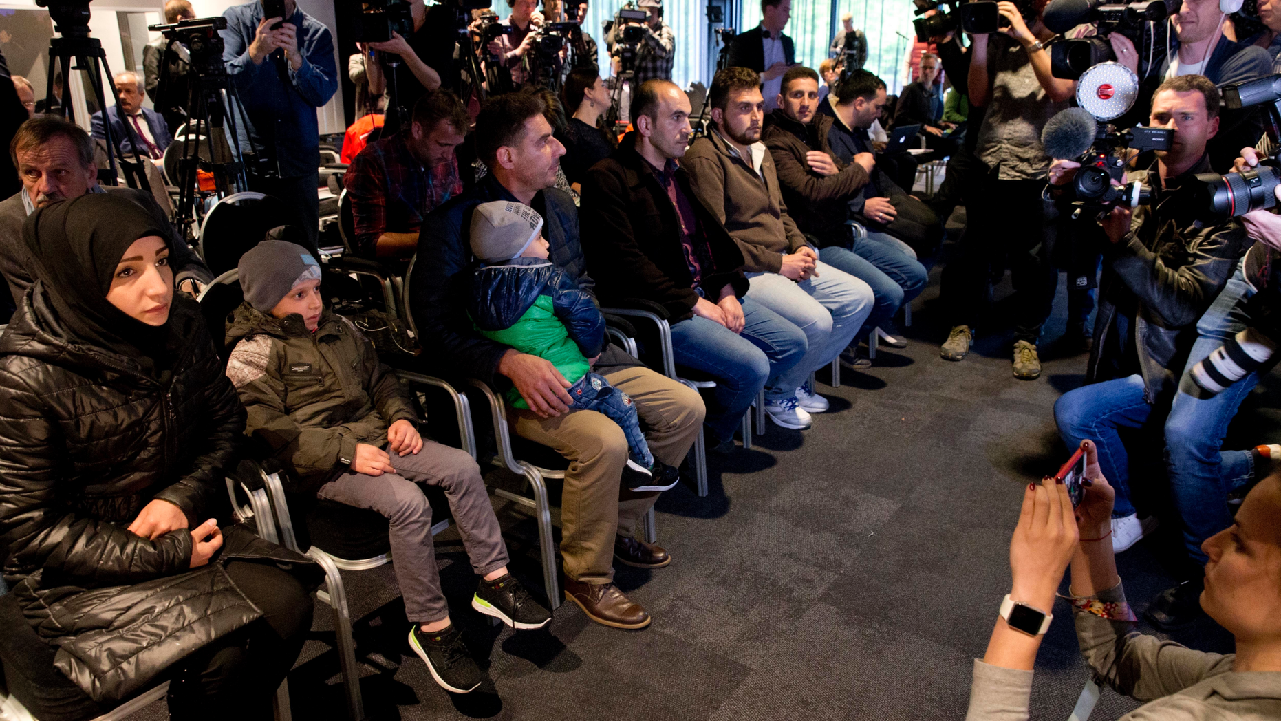 FILE - In this file photo dated Thursday, April 26, 2018, Syrians brought to The Hague by Russia face the media, in a move to discredit reports of an April 7, 2018, chemical weapons attack in the Syrian town of Douma, in The Hague, Netherlands. At a heated session of the Organization for the Prohibition of Chemical Weapons’ annual conference, on Monday Nov. 19, 2018, western powers clashed with Russia over a decision to set up a new investigative team which could name the perpetrators of chemical attacks. (AP Photo/Peter Dejong, FILE)