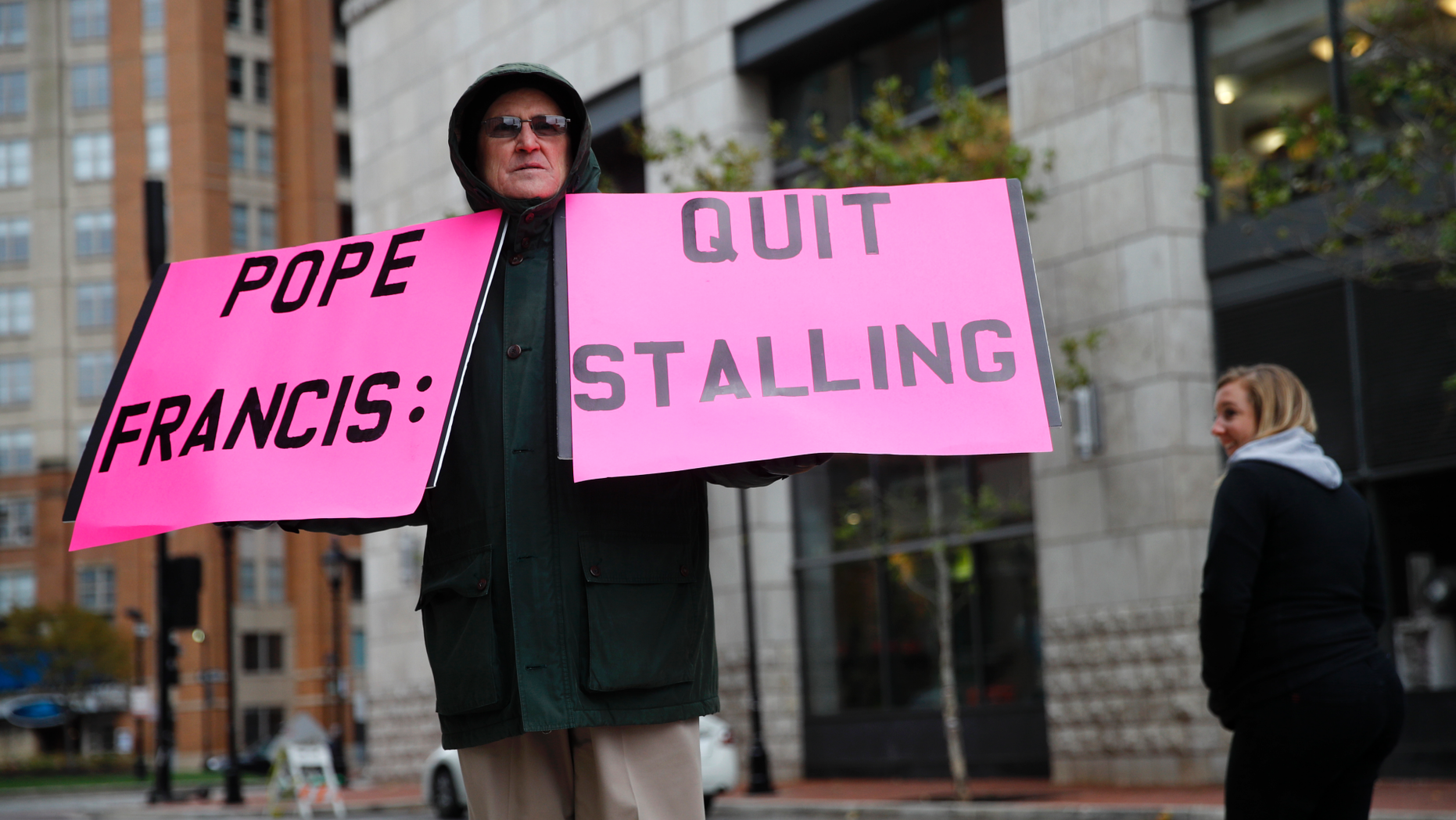 Robert Hoatson, of West Orange, N.J., holds protest signs outside of a hotel hosting the United States Conference of Catholic Bishops' annual fall meeting, Tuesday, Nov. 13, 2018, in Baltimore. (AP Photo/Patrick Semansky)