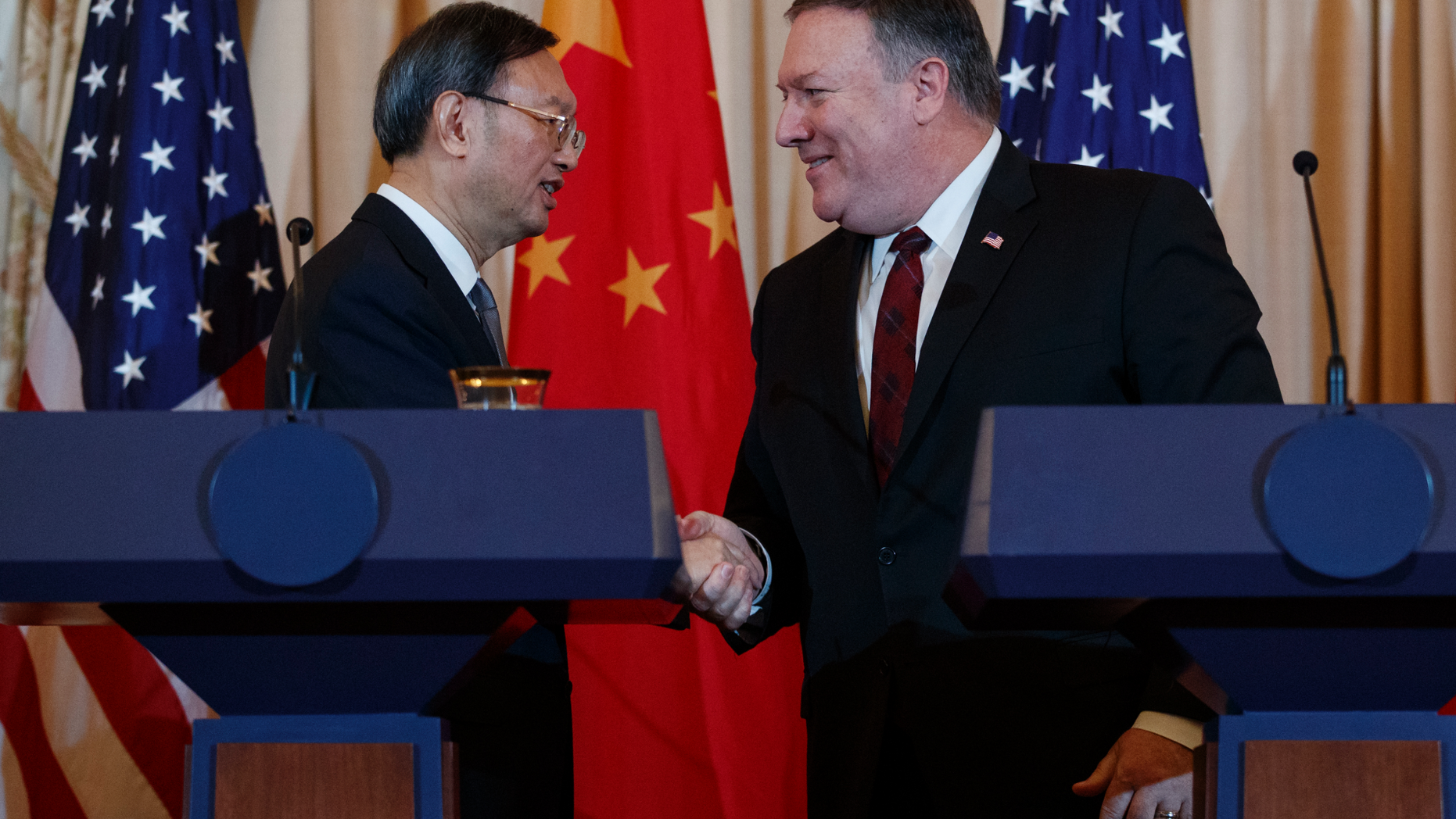 Secretary of State Mike Pompeo, right, shakes hands with Chinese Politburo Member Yang Jiechi at the conclusion of a news conference at the State Department in Washington, Friday, Nov. 9, 2018. (AP Photo/Carolyn Kaster)