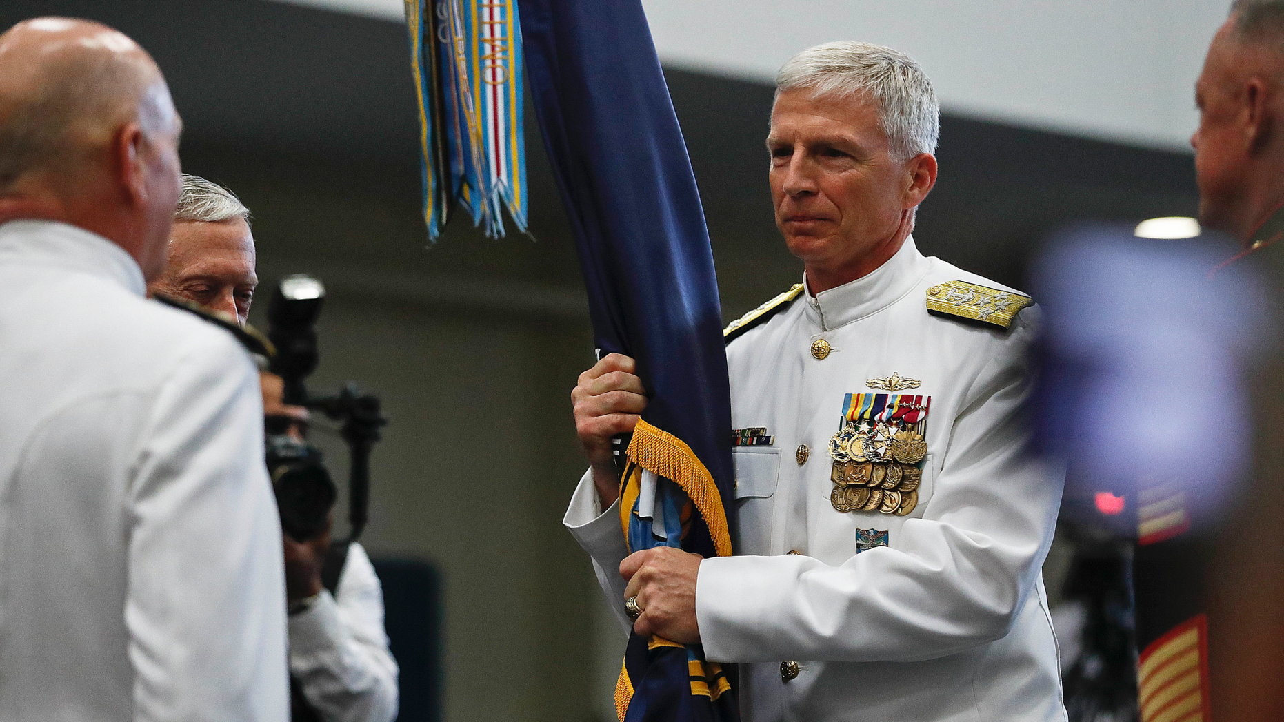 U.S. Navy Adm. Craig Faller, center, assume command from U.S. Navy Adm. Kurt Tidd, left, during a change of command ceremony at the U.S. Southern Command headquarters on Monday, Nov. 26, 2018, in Doral, Fla. (AP Photo/Brynn Anderson)