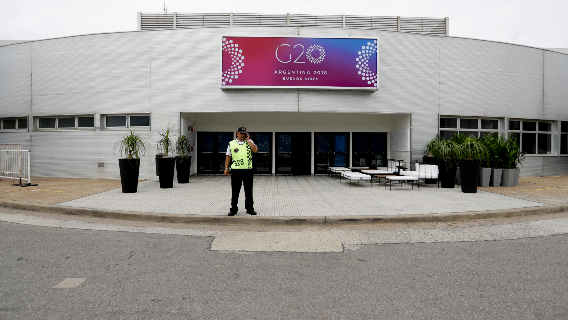 A security guard stands outside the G20 summit venue at the Costa Salguero Center, Buenos Aires, Argentina, Tuesday, Nov. 27, 2018. Thousands of police and security agents will guard Group of 20 industrialized nations' world leaders during the two-day meeting that starts Friday. (AP Photo/Natacha Pisarenko)