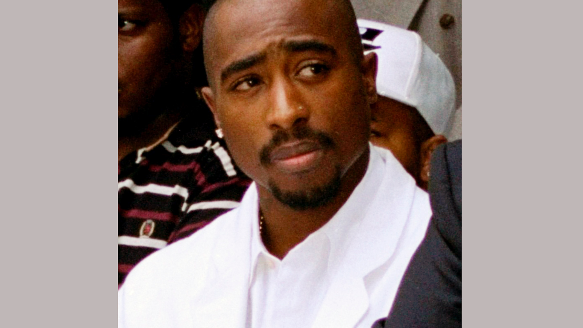 FILE - In this Aug. 15, 1996, file photo, rapper Tupac Shakur attends a voter registration event in South Central Los Angeles. Items owned by Shakur have been donated to Temple University, including a bullet-dented golden medallion the rapper was wearing in 1994 when he was shot five times. Diane Turner, the collection's curator, said Thursday, Nov. 1, 2018, that the Blockson Collection will increase its focus on hip-hop culture with the addition of Shakur's items. (AP Photo/Frank Wiese, File)