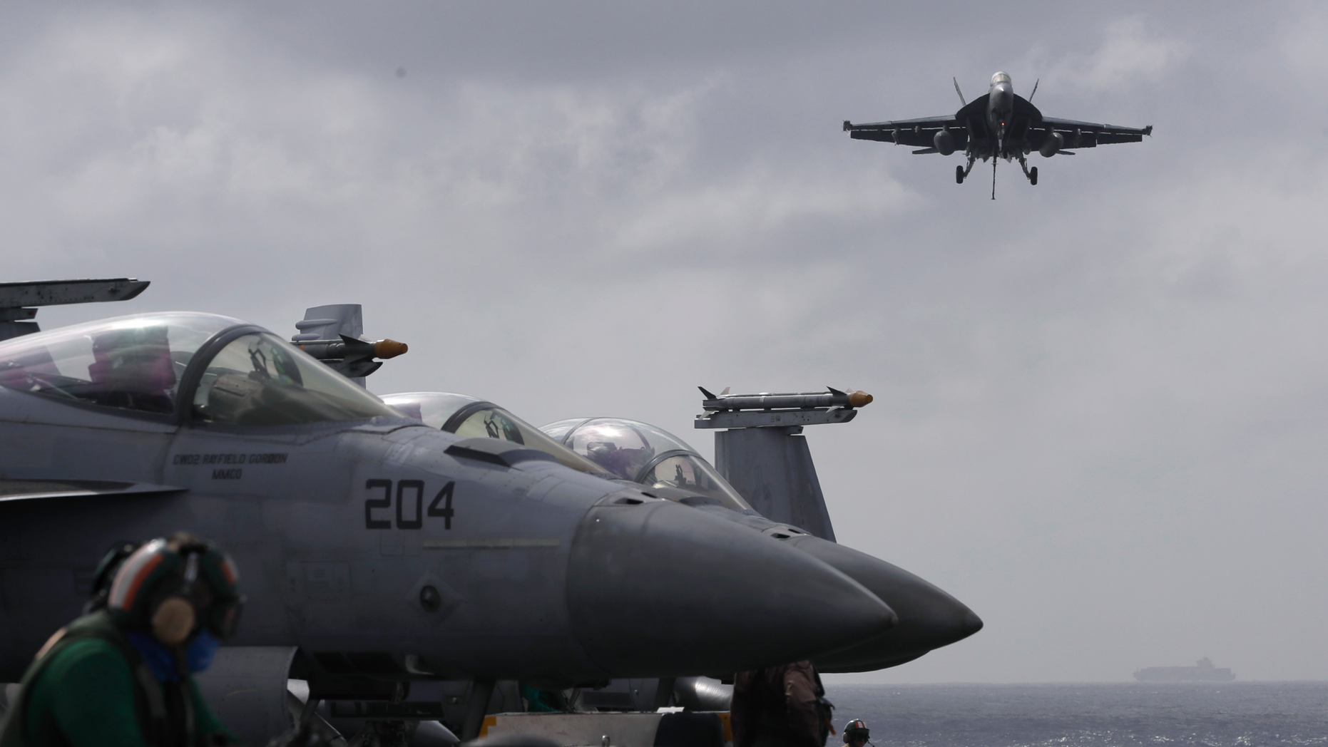 An F/A-18 Super Hornet fighter jet lands on the deck of the U.S. Navy USS Ronald Reagan in the South China Sea, Tuesday, Nov. 20, 2018. China is allowing the carrier and its battle group to make a port call in Hong Kong after it earlier turned down a similar request amid tensions with Washington. (AP Photo/Kin Cheung)