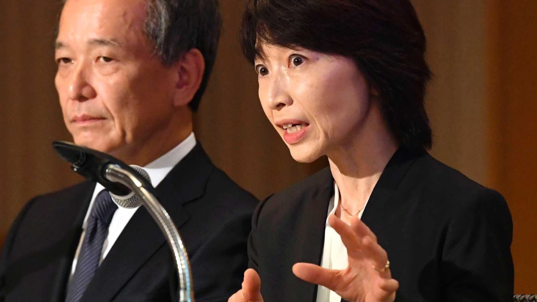Tokyo Medical University President Yukiko Hayashi, right, speaks during a press conference in Tokyo, Wednesday, Nov. 7, 2018. The Japanese medical university that has acknowledged systematically discriminating against female applicants has announced plans to accept more than 60 who had been unfairly rejected in the past two years. The discriminatory policy at Tokyo Medical University surfaced earlier this year, triggering national outrage. The school acknowledged in August that it has been slashing female applicants' entrance exam scores for years to keep the female student population low, saying women tend to quit as doctors after starting families.(Kyodo News via AP)
