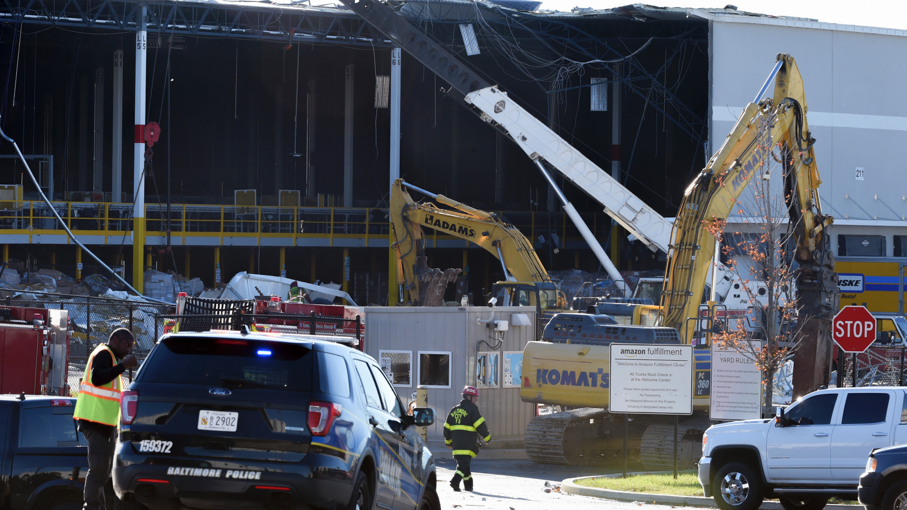 Emergency personnel look over damage, Saturday, Nov. 3, 2018, after a weather-related building collapse at an Amazon distribution warehouse on Baltimore's southeast side Friday night. Chief Roman Clark tells the Sun that a 50-foot wall collapsed late Friday at the Amazon Fulfillment Center as a storm hit the area. (Ulysses Munoz/The Baltimore Sun via AP)