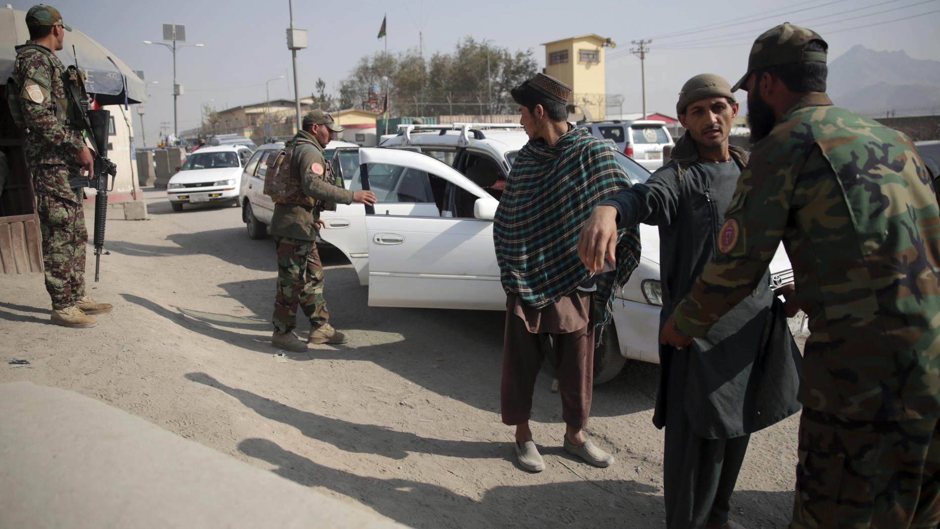 In this Oct. 26, 2018 photo, Afghan National Security Forces search passengers and their vehicles at a checkpoint in Kabul, Afghanistan. Afghans, who once welcomed Americans as liberators, now increasingly see them as the architects of their country’s demise. The United States has lost more than 2,400 soldiers in its longest war and spent more than $900 billion on trying to stabilize the country. (AP Photo/Massoud Hossaini)